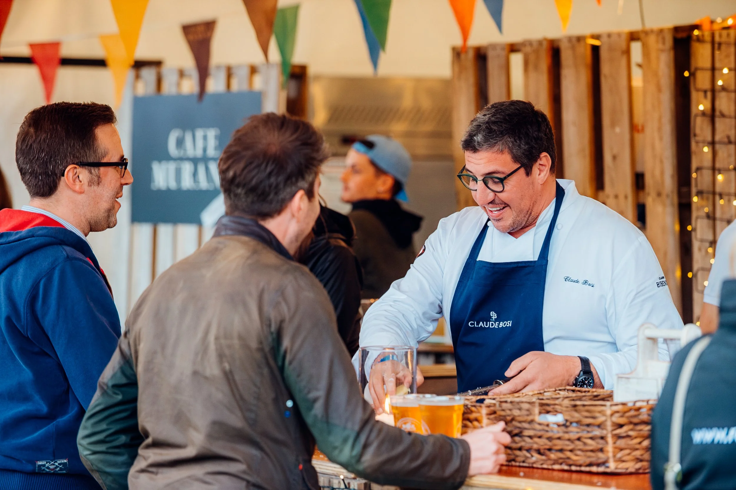Decorated Michelin-starred chef Claude Bosi interacting with festivalgoers at his custom outdoor popup kitchen during Pub in the Park in Marlow. Culinary festival and premium experiential food photography by Will Bailey.