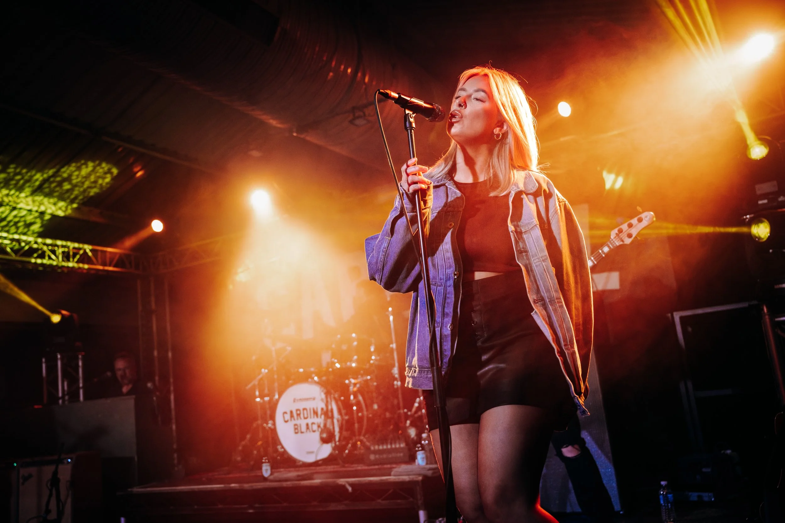 Vocalist, Tay Cousins, of soul-rock band Cardinal Black delivering an emotive vocal performance under warm stage tracking lights at a popular live stage in Southampton, Hampshire. Independent music scene and intimate tour venue photography by Will Ba