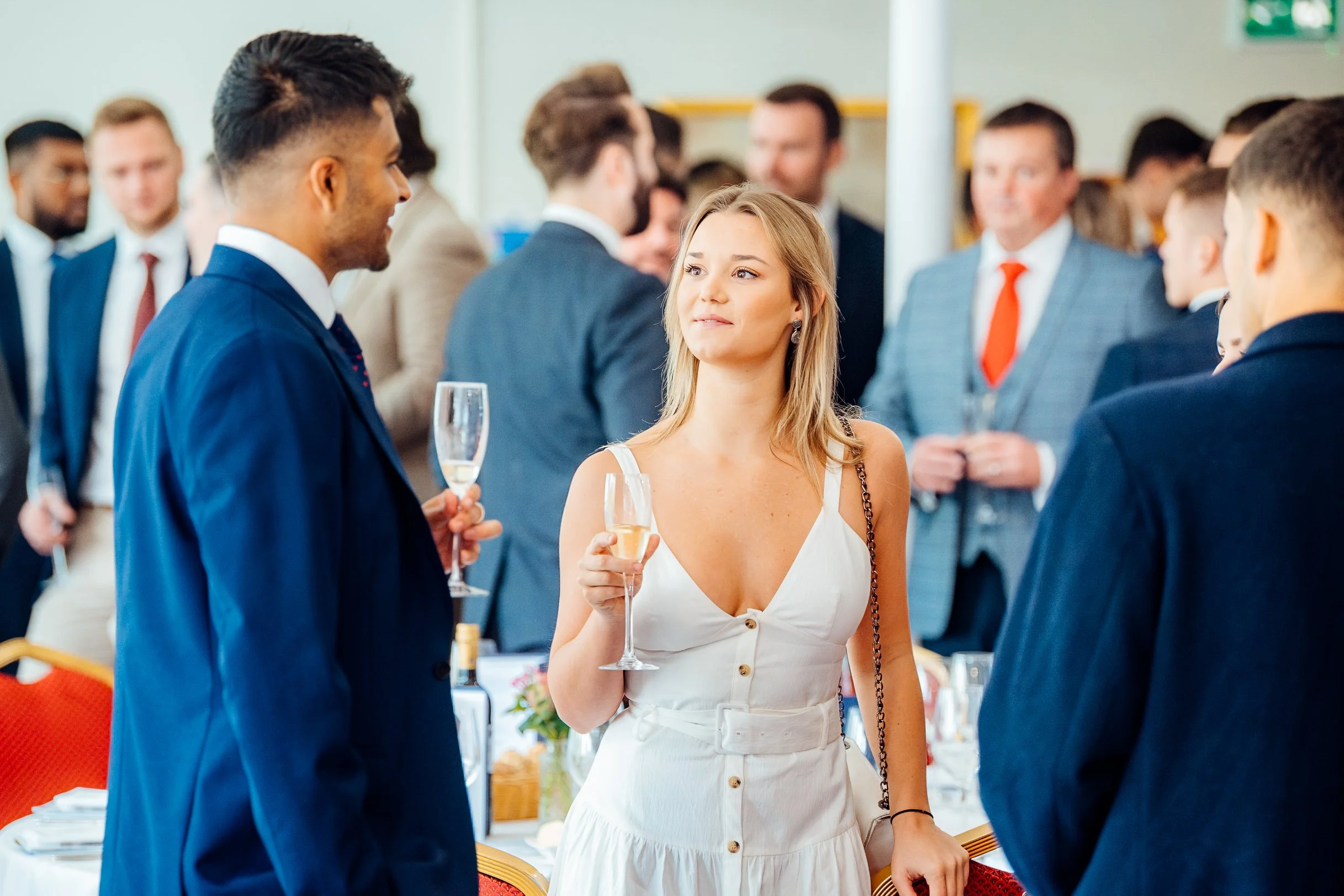 Corporate professionals networking over champagne at the GetGround business event at Ascot. Candid corporate hospitality and networking photography by Will Bailey.