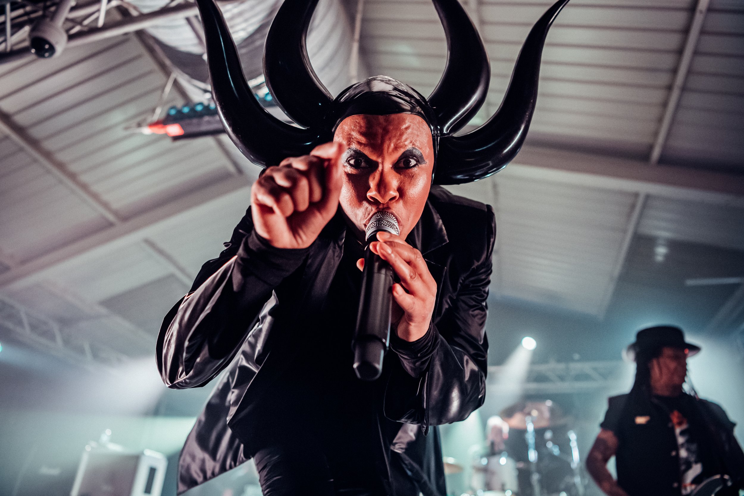 A dramatic close-up portrait of Skin from Skunk Anansie in an elaborate horned headpiece performing live in Southampton. High-impact rock concert and expressive live stage performance photography by Will Bailey.