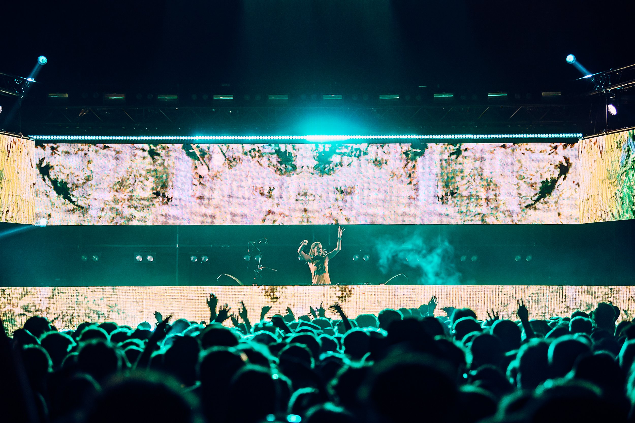 Atmospheric electronic festival photography of LP Giobbi performing a live DJ set under teal LED stage screens at Boardmasters Festival, captured by music photographer Will Bailey.
