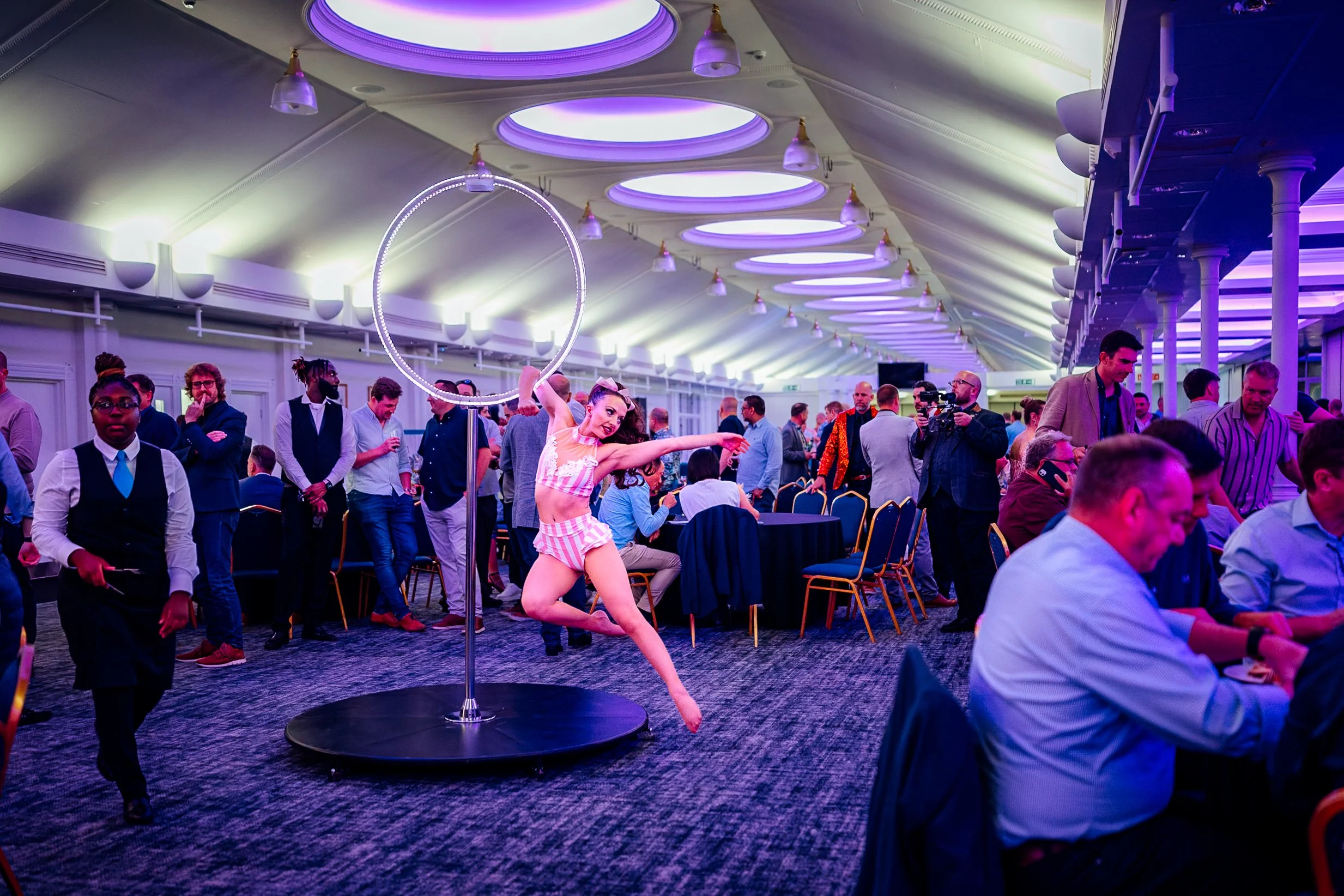 An aerial hoop acrobat performing live during the evening dinner at the Midwich Tech Xpo, hosted at Ascot. Experiential corporate entertainment and gala photography by Will Bailey.