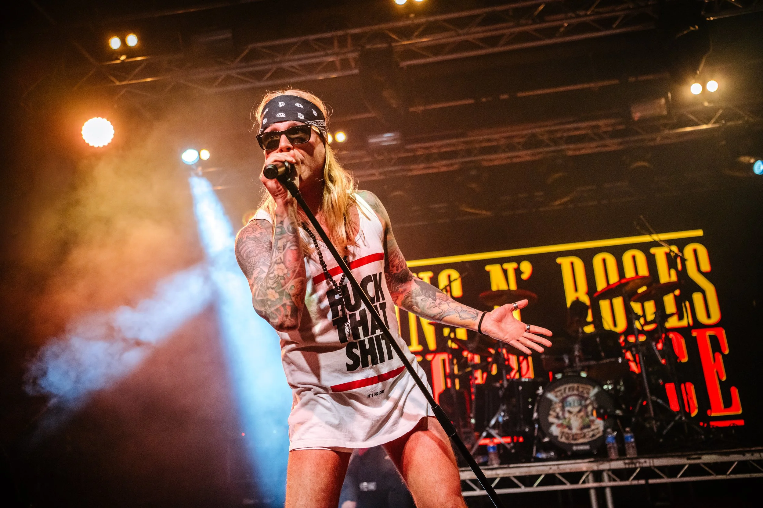 A tribute lead vocalist from Guns 2 Roses performing classic rock hits live on stage to a packed crowd during the Giants of Rock event at the Engine Shed in Lincoln. Regional live music entertainment and rock cover band photography by Will Bailey.