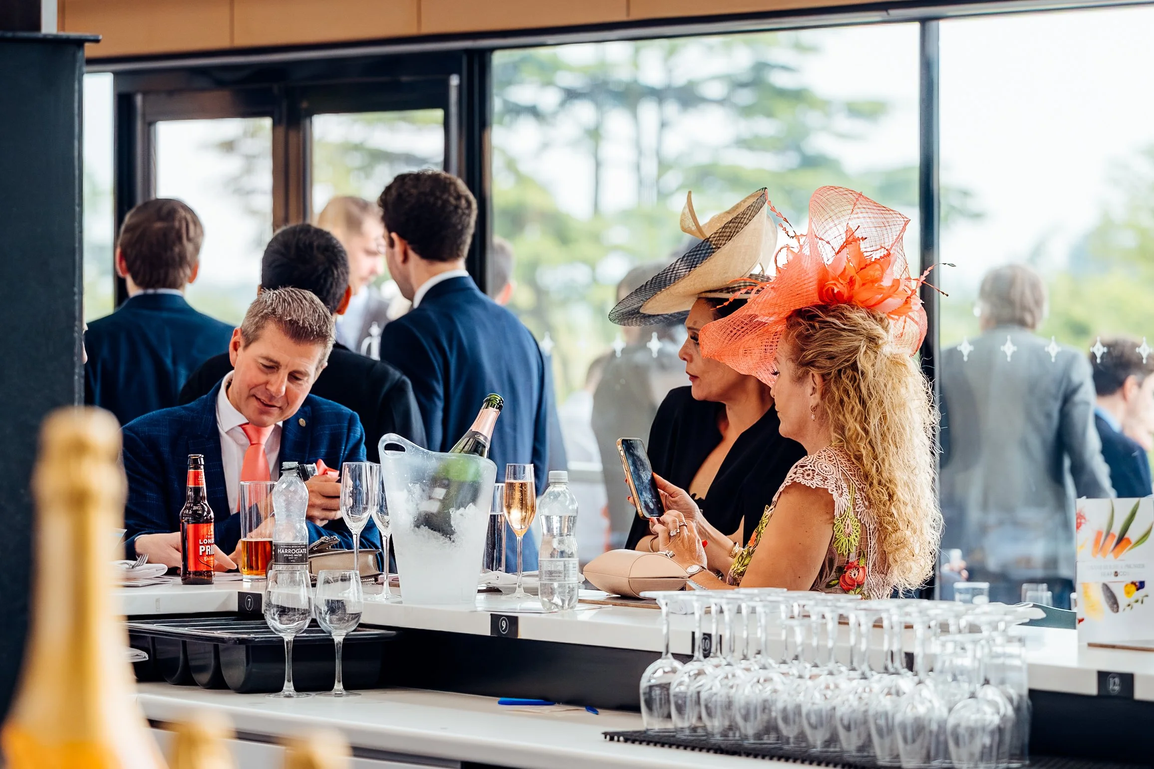 Corporate hospitality guests enjoying the Victoria Cup Race Day at Ascot. Premium commercial lifestyle and corporate networking photography by Will Bailey.