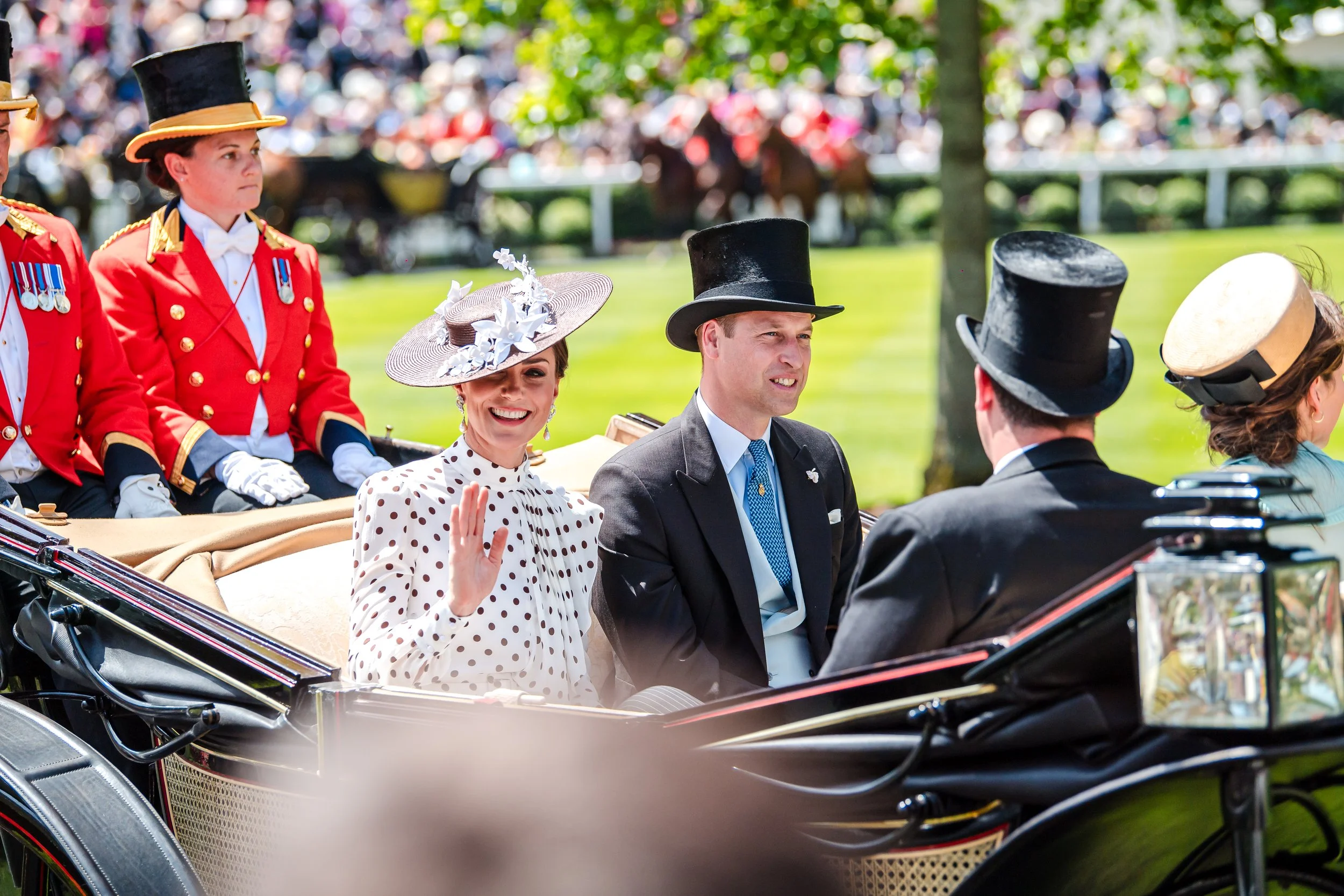 The Prince and Princess of Wales, William and Kate, arriving in an open-top horse-drawn carriage during the Royal Procession at Royal Ascot. Editorial British lifestyle and prestigious cultural event photography by Will Bailey.