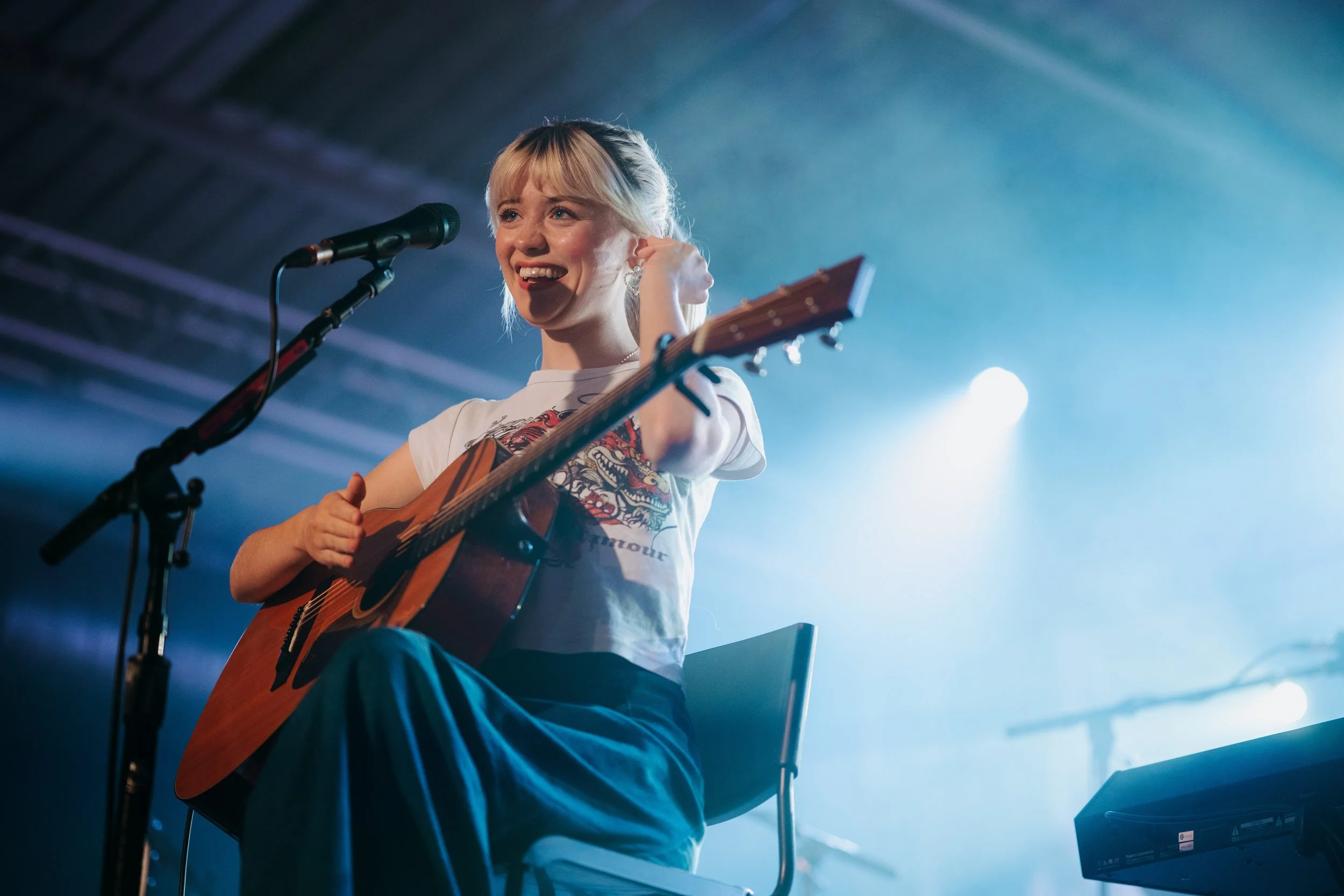 Singer-songwriter Maisie Peters performing an intimate acoustic set with her guitar at a leading live music venue in Southampton, Hampshire. Emerging UK pop artist tour coverage and professional concert photography by Will Bailey.