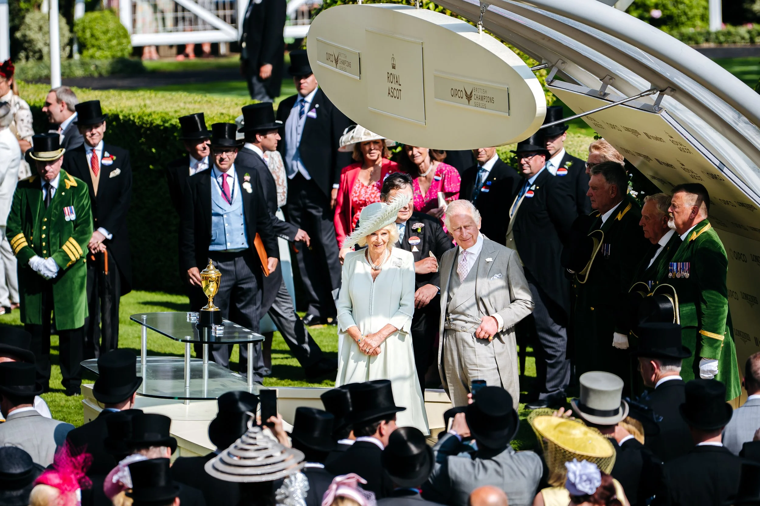 King Charles III and Queen Camilla attending a formal presentation ceremony inside the parade ring at Royal Ascot, Berkshire. Elite British heritage and prestigious seasonal event photography by Will Bailey.