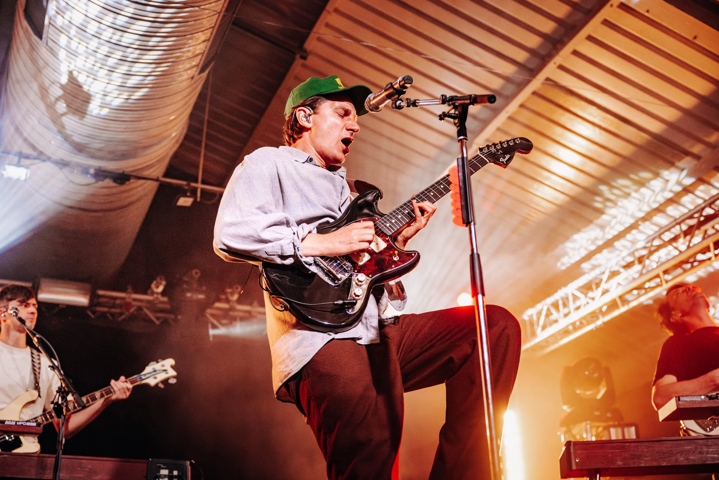 Frontman Dave Bayley of indie pop band Glass Animals performing intensely while rocking a green cap at a popular Hampshire live room in Southampton. Professional band promotion and independent touring artist photography by Will Bailey.