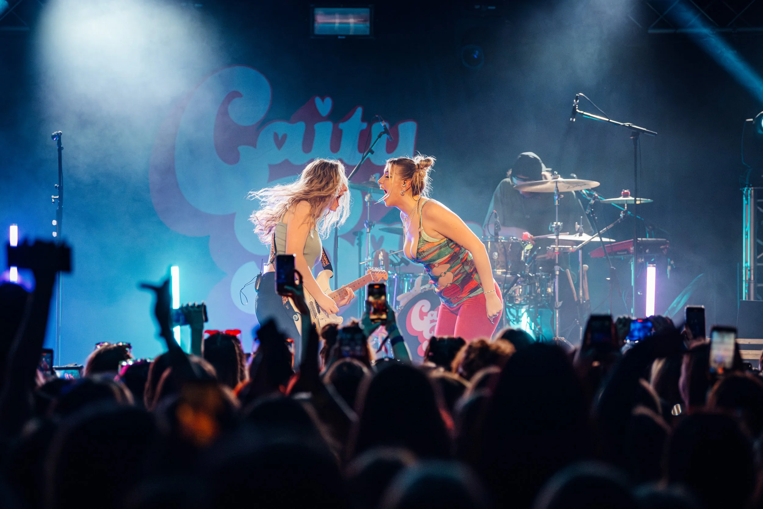 Pop artist Caity Baser sharing a high-energy vocal moment with her guitarist in front of a packed crowd at a prominent South Coast live room in Southampton. Candid live music performance and emerging UK pop artist photography by Will Bailey.