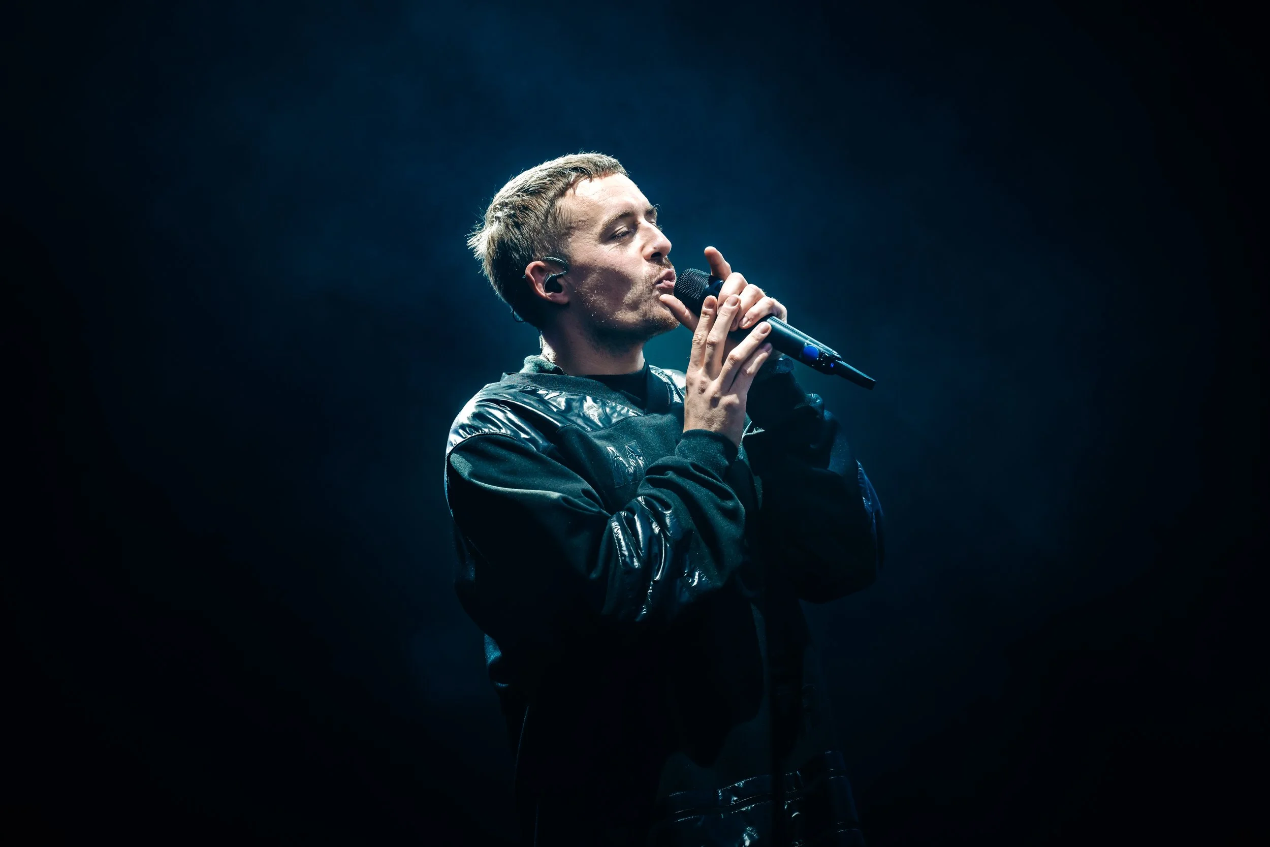 Irish singer-songwriter Dermot Kennedy delivering an emotional, atmospheric performance under moody stage lights at Boardmasters Festival in Cornwall. Major music festival headliner and live concert photography by Will Bailey.