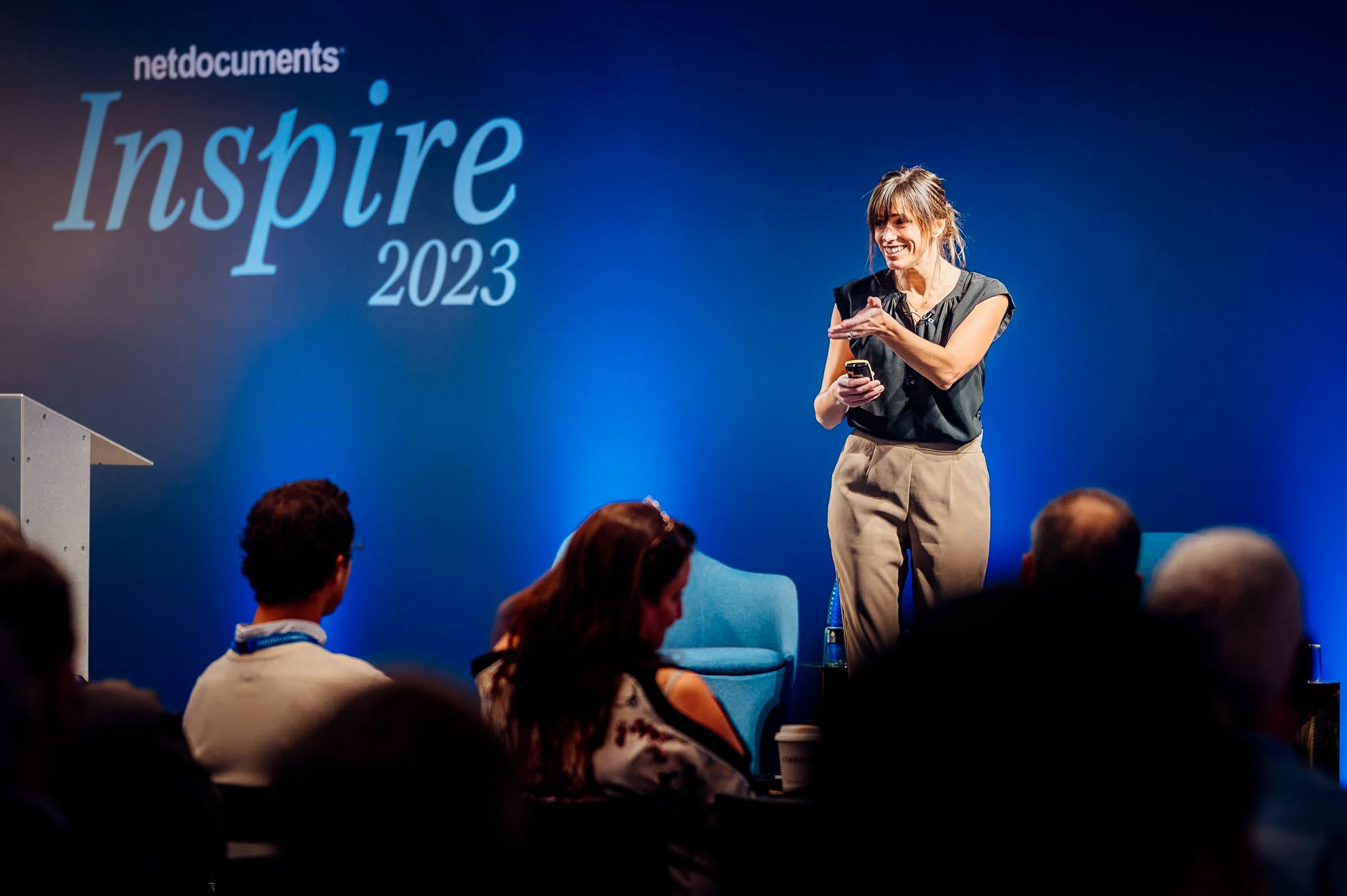 A keynote speaker presentation on stage at the NetDocuments Inspire conference, hosted at Convene 22 Bishopsgate, London. Professional corporate event photography by Will Bailey.