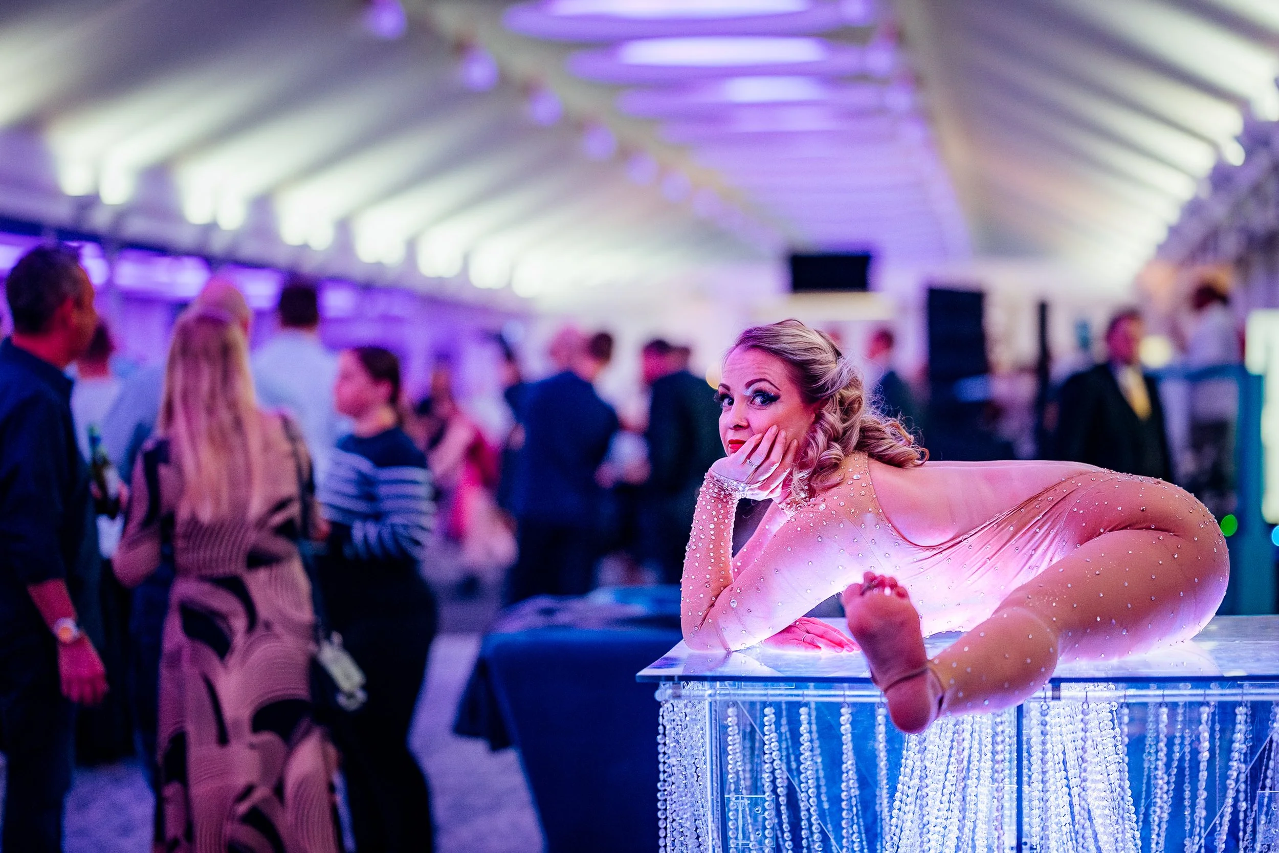 A contortionist entertainer performing live during the evening gala dinner at the Midwich Tech Xpo, hosted at Ascot. Premium corporate hospitality and experiential event photography by Will Bailey.