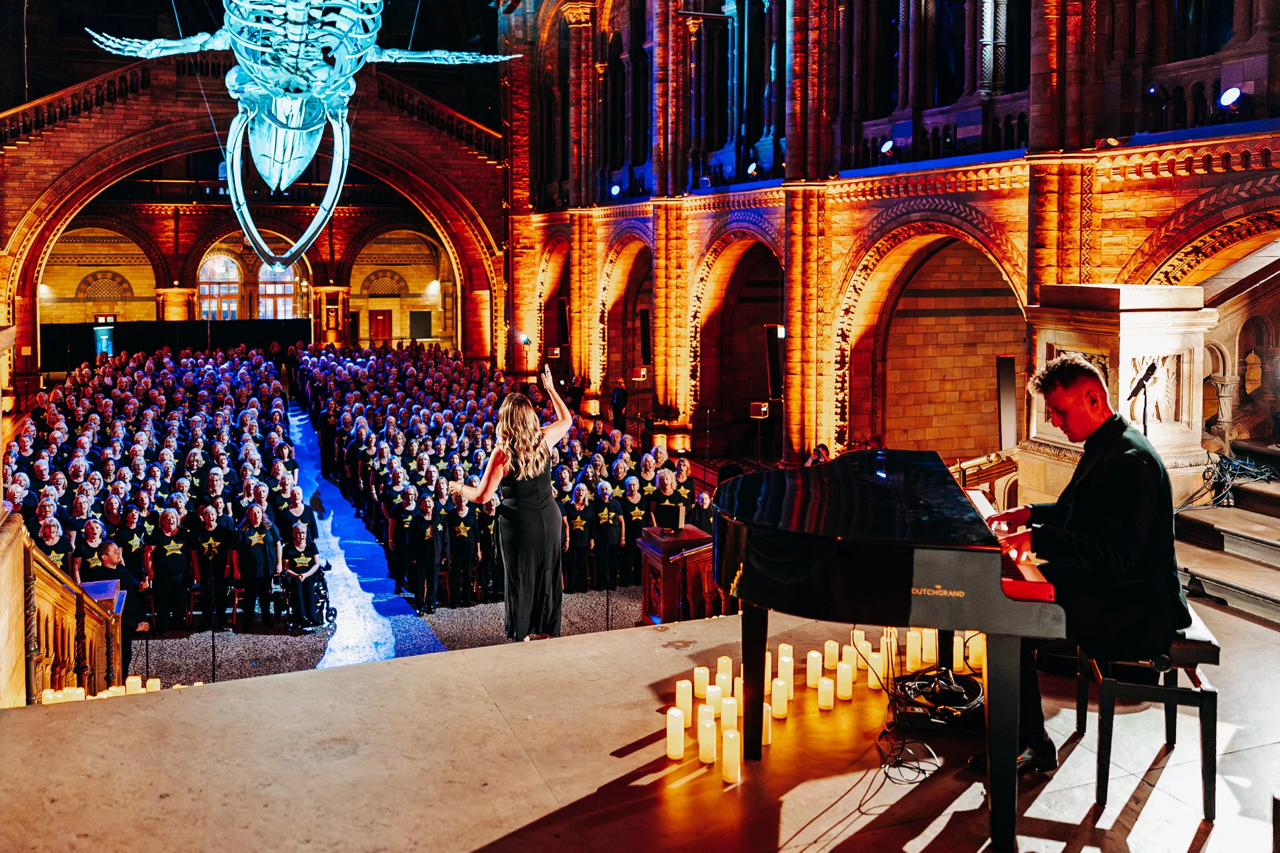 London event photographer Will Bailey captures Rock Choir’s candlelit performance beneath Hope the blue whale at the Natural History Museum.