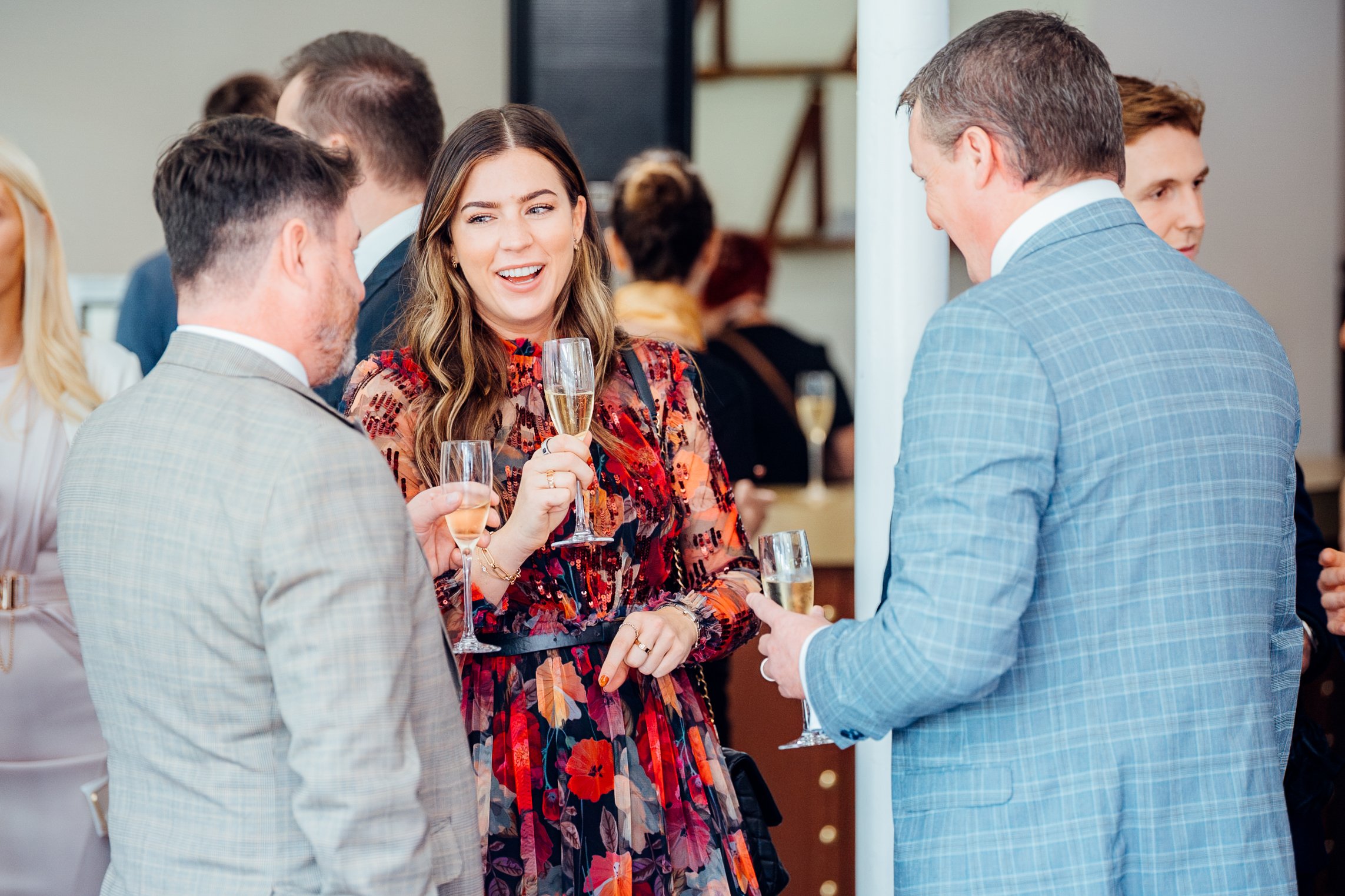 Attendees sharing a candid champagne toast during the GetGround corporate networking hospitality at Ascot. High-end business event lifestyle photography by Will Bailey.