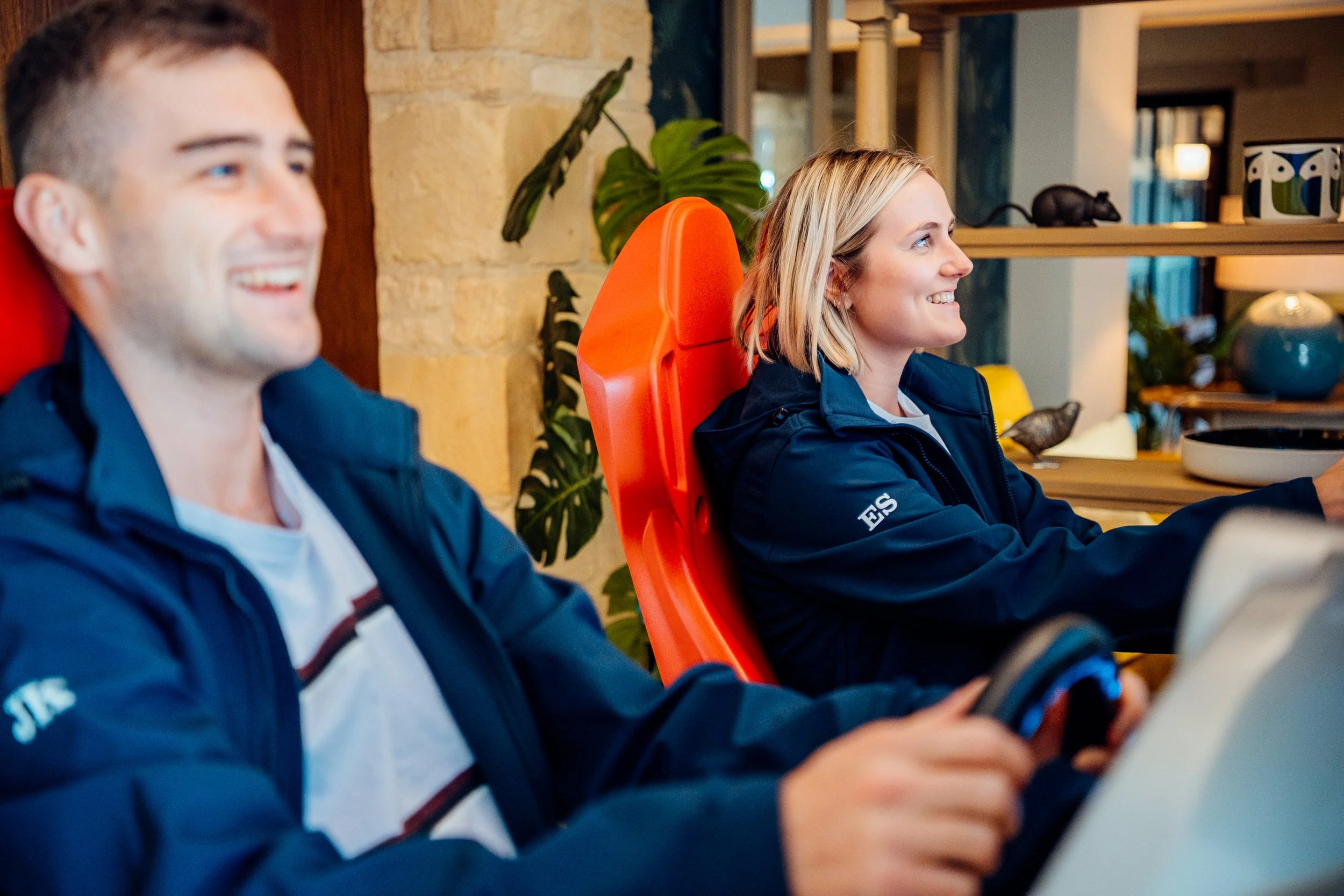 Top-performing employees enjoying an immersive driving simulator experience during an incentive corporate away day for Chambers and Partners. Corporate culture and reward event photography by Will Bailey.