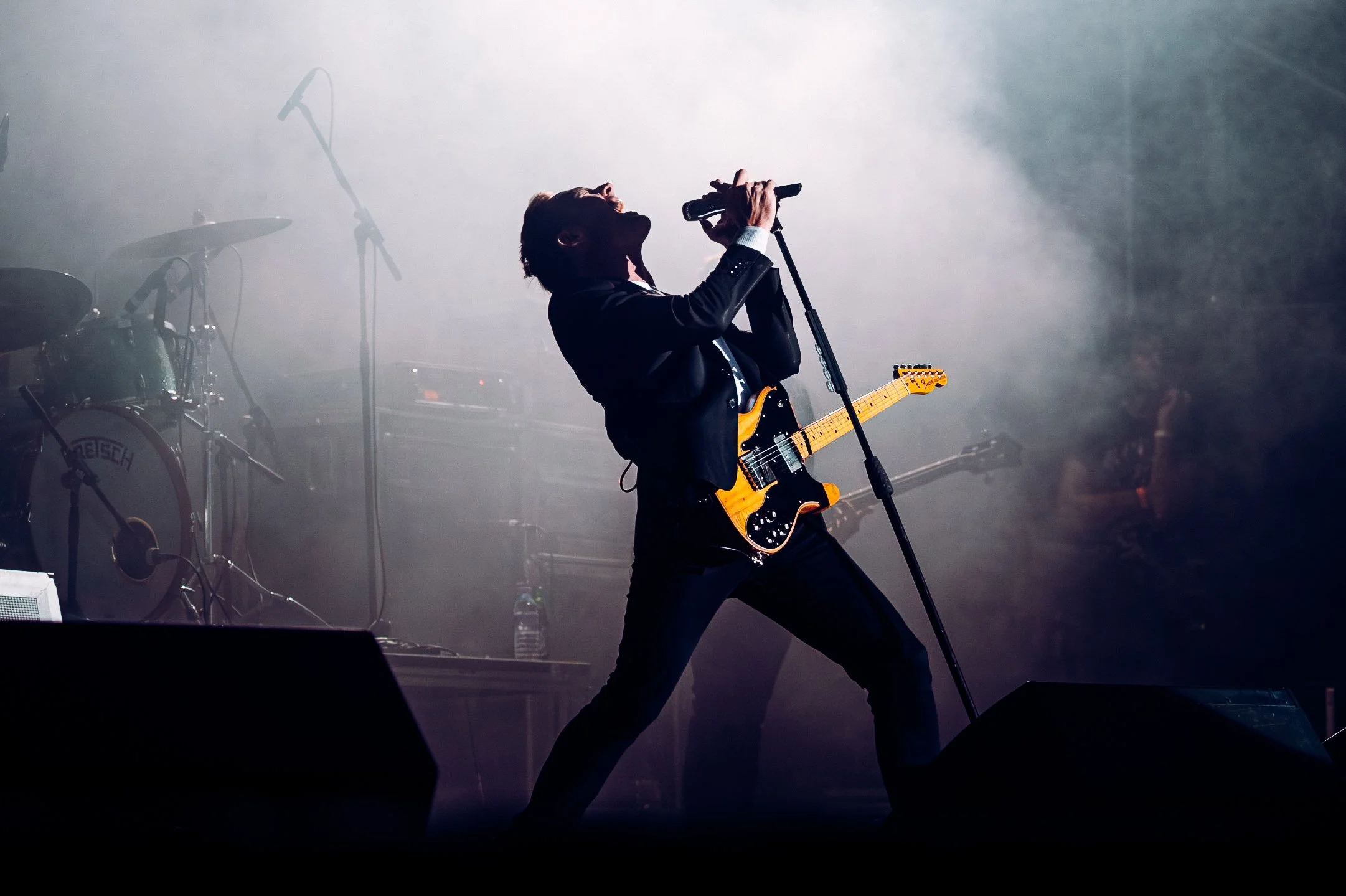 The Feeling delivering an energetic live performance amidst edgy stage smoke at CarFest in Basingstoke, Hampshire. Professional summer festival stage action and editorial live music photography by Will Bailey.
