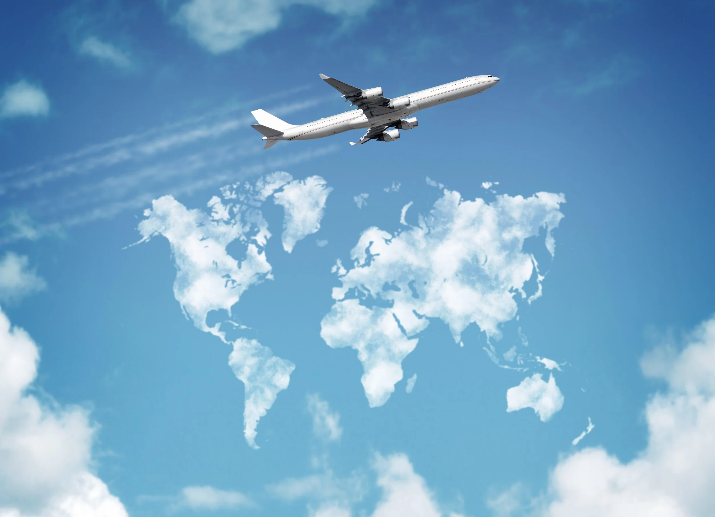 An airplane flying in the sky above a map of the world with clouds.