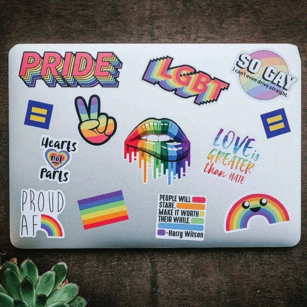 Laptop decorated with LGBTQ+ pride and equality stickers