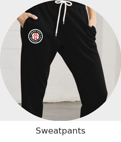 Person wearing black sweatpants with a white drawstring and logo on the left thigh.