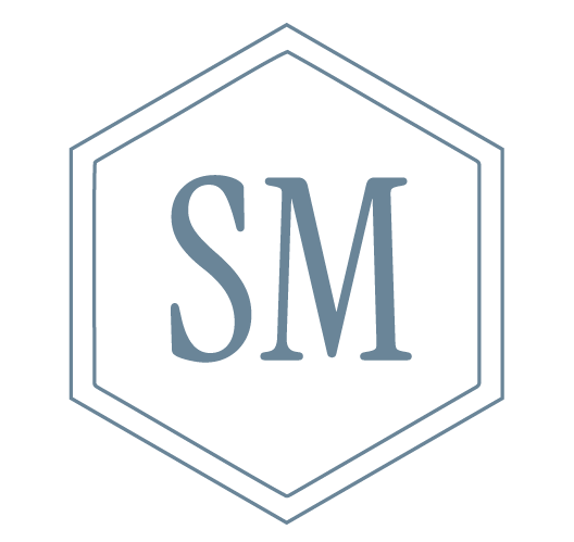 A logo with the initials "SM" inside a hexagon outline on a black background.