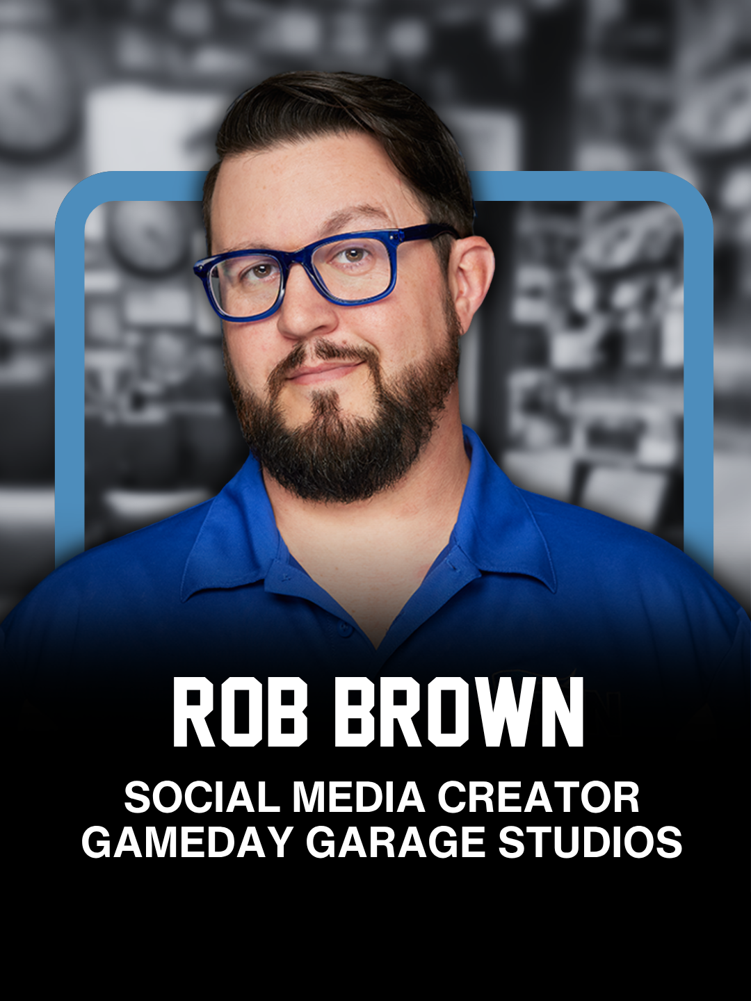 A portrait of Rob Brown, a man with glasses, a beard, and short dark hair, wearing a blue shirt, against a blurred background of a garage or workshop with tools.
