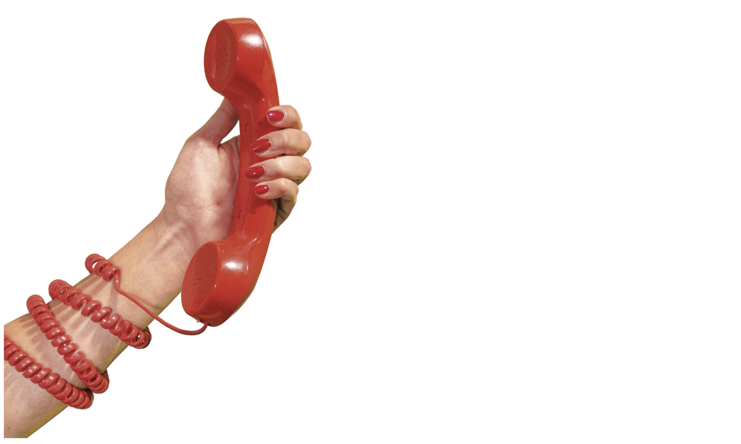 Hand holding a red rotary telephone against a white background, with red bracelets on the wrist.