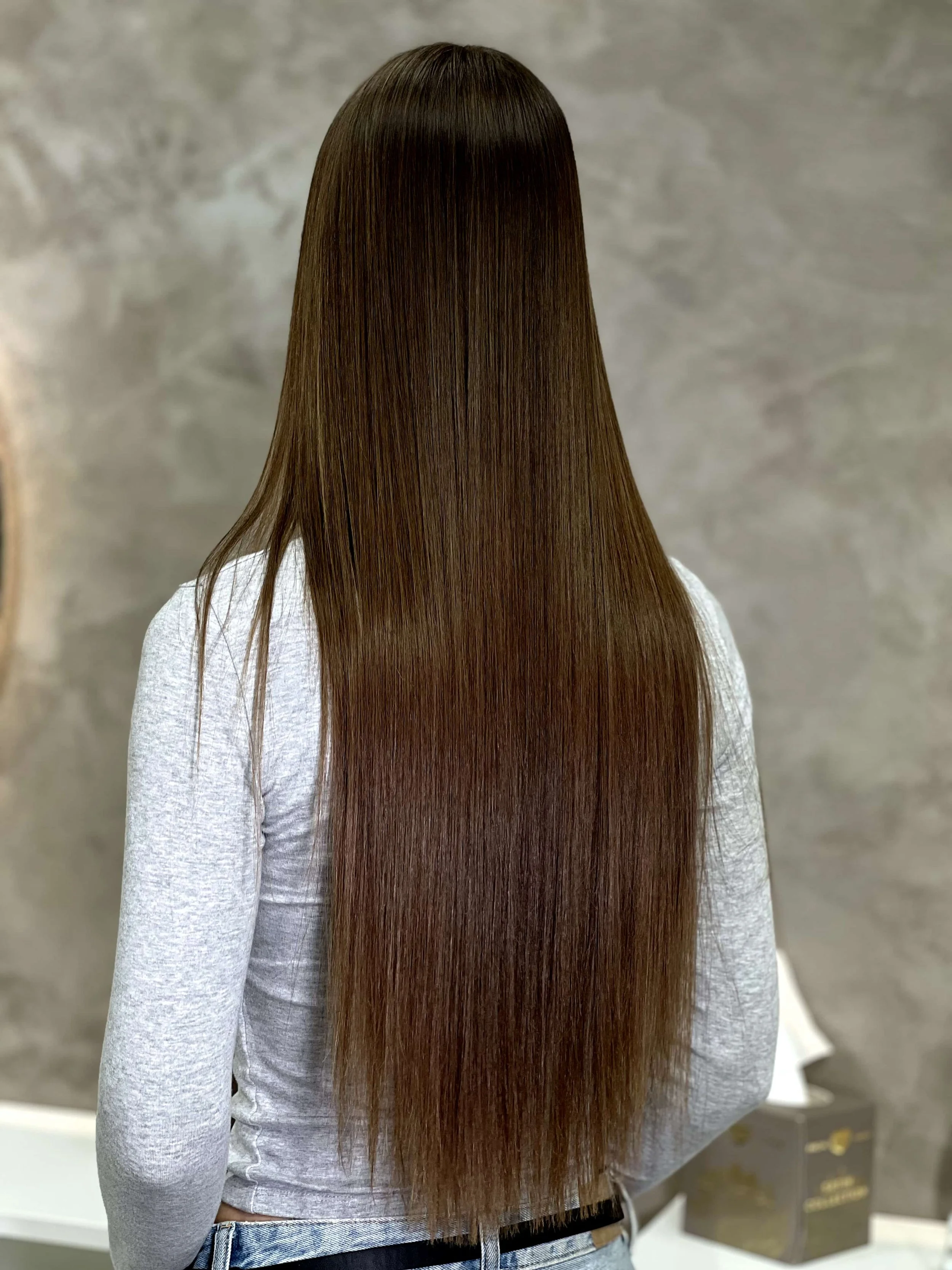 Flawless, shiny hair result after professional reconstruction treatment in Riga