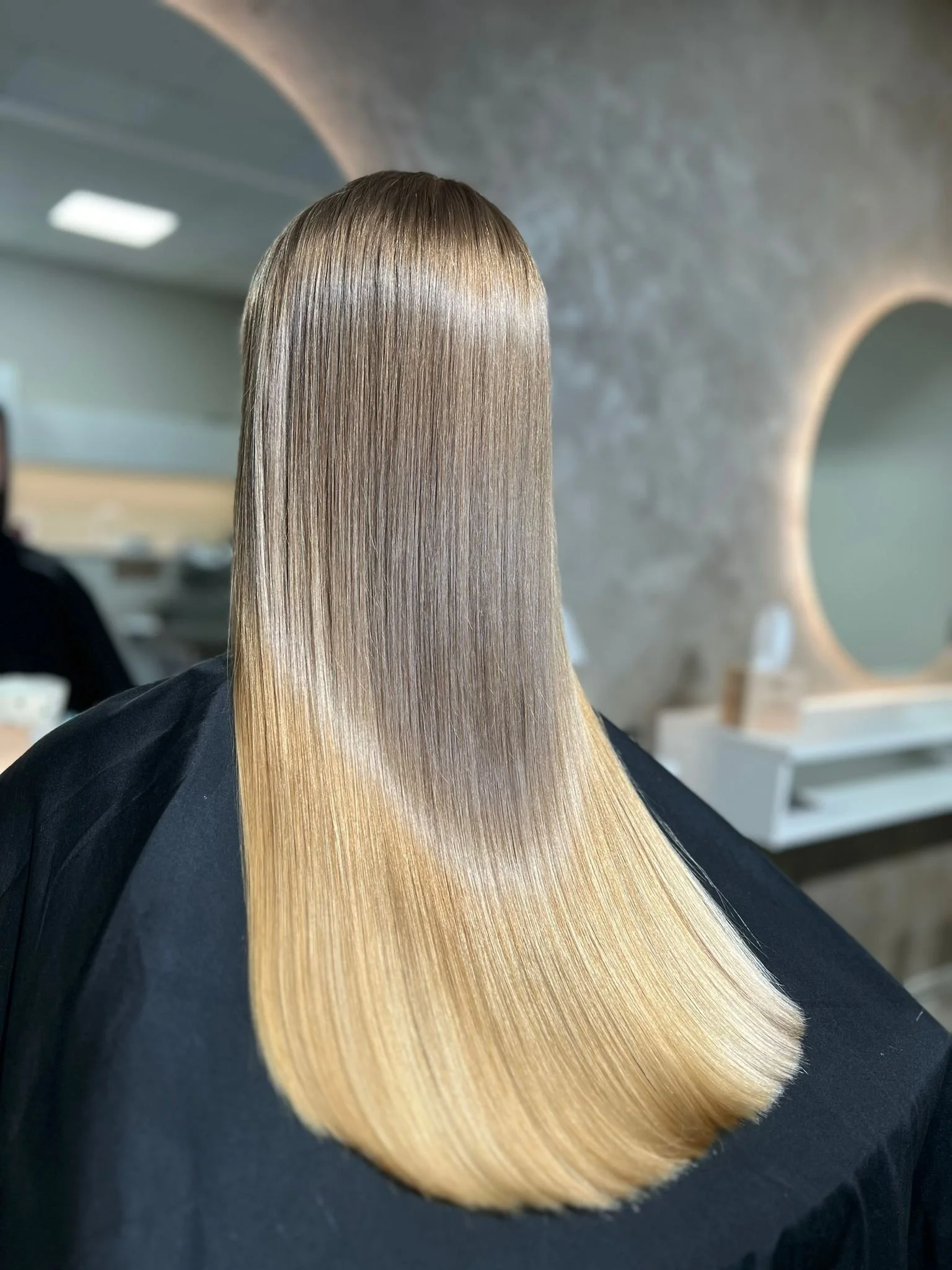 Flawless, smooth blonde hair after professional reconstruction treatment in Riga
