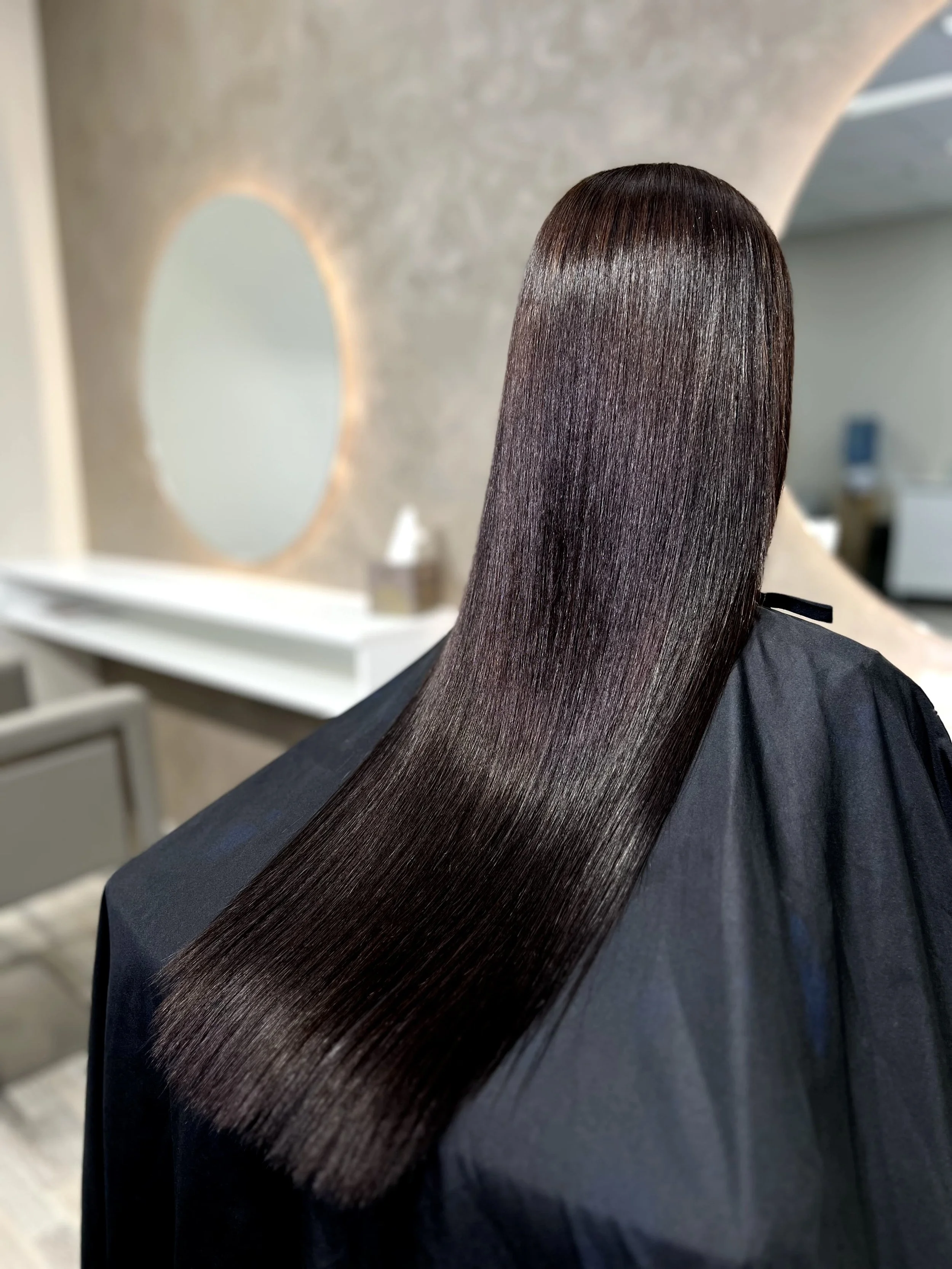 Shiny, straight dark brown hair result after premium hair care service