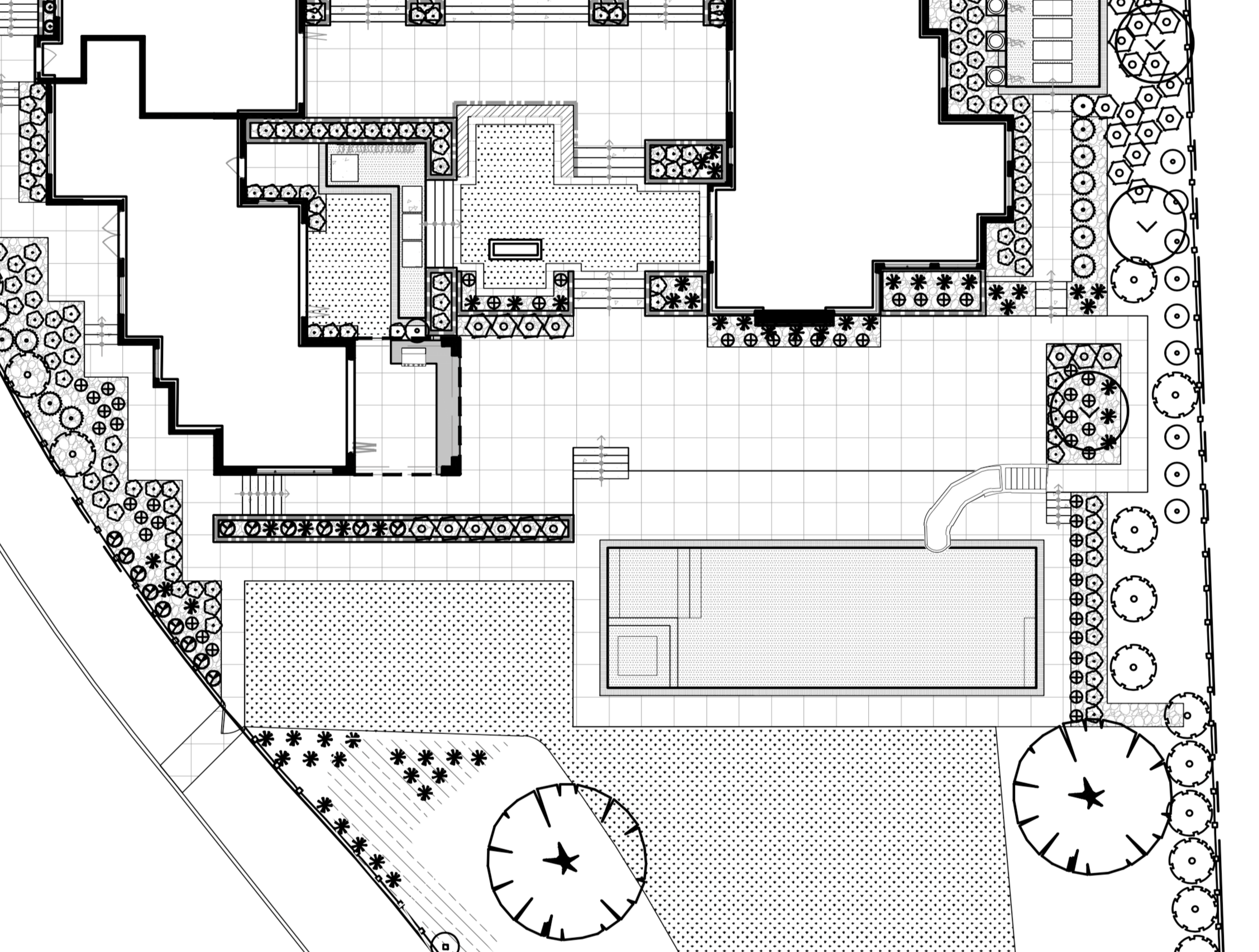 Architectural site plan showing outdoor areas with landscaped gardens, walking paths, stairs, and landscaped circular features with star symbols.