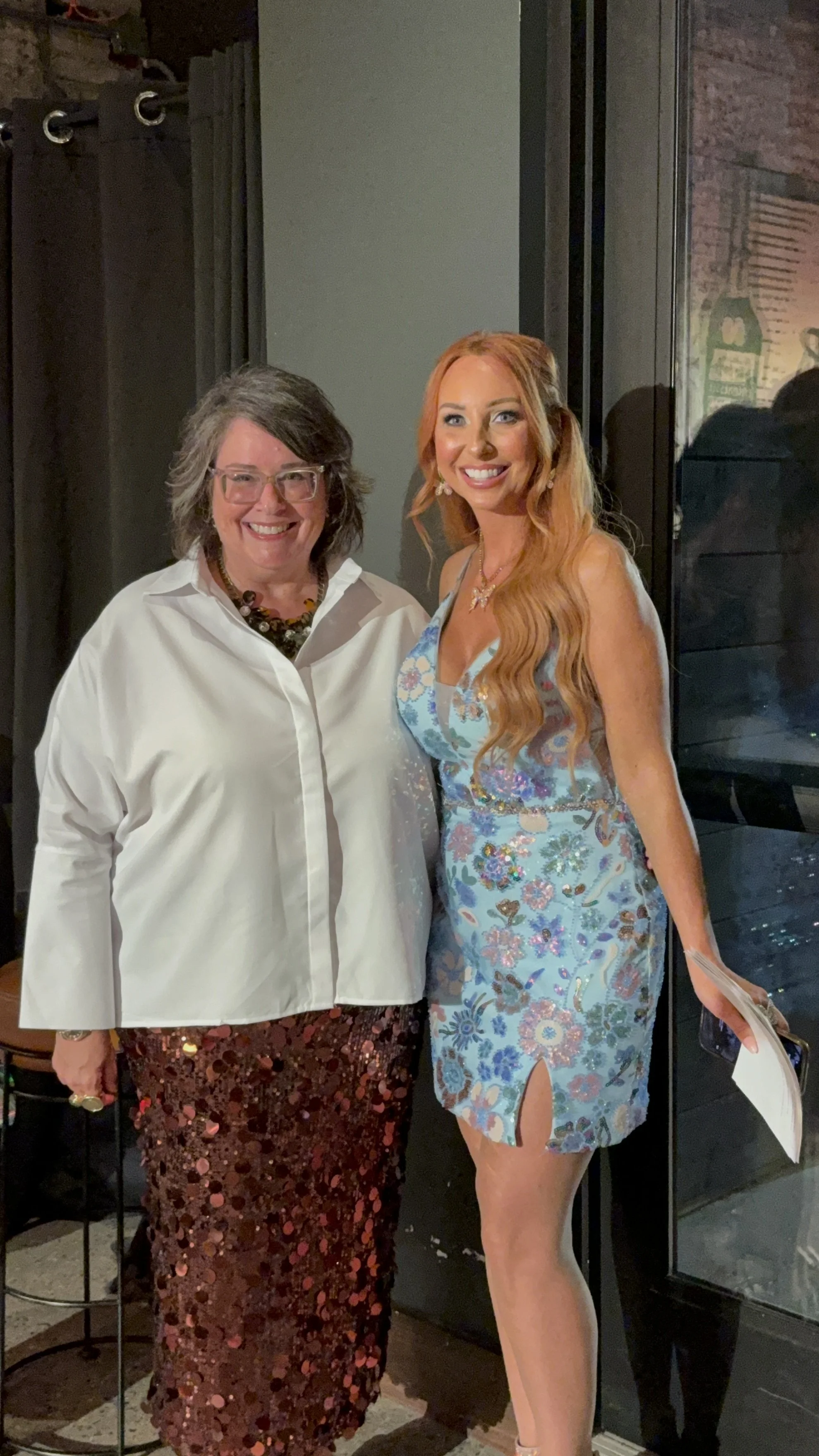 AMLA agent Danielle and co-emcee Becca Bowen pose by the wine pull 