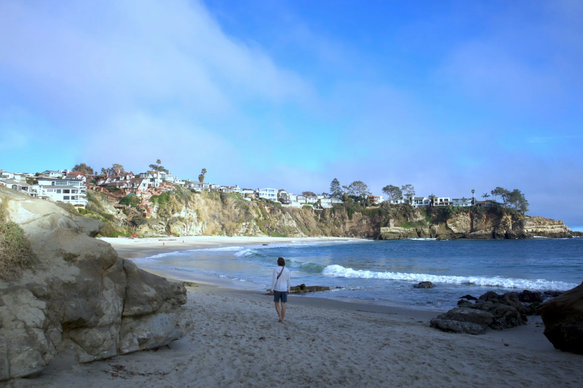 A man walking down one of Laguna Niguel's beaches