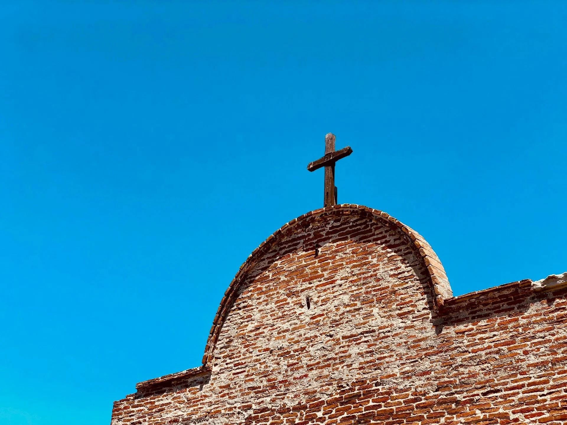 The cross on top of one of the San Juan Capistrano mission buildings