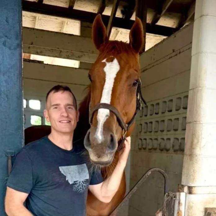 Luke at LHS Equine standing with a horse inside a stable at an equestrian training facility in Central Virginia offering horse training, boarding, and rider development