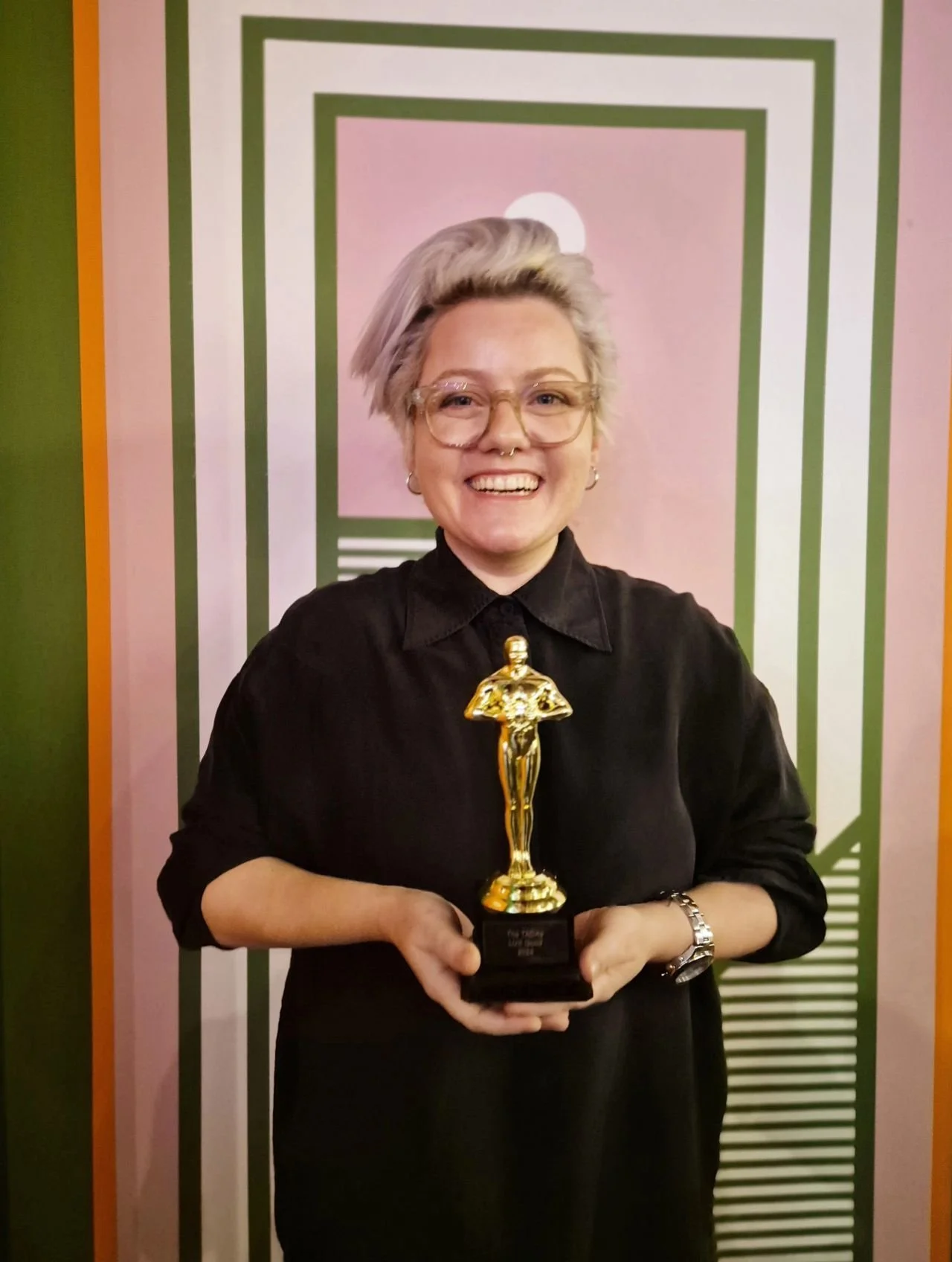 Georgia holding an award for best UX at Bupa