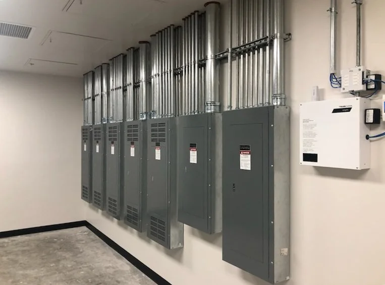 Large-scale commercial electrical distribution panels installed with precision conduit work and code-compliant power infrastructure for industrial applications.