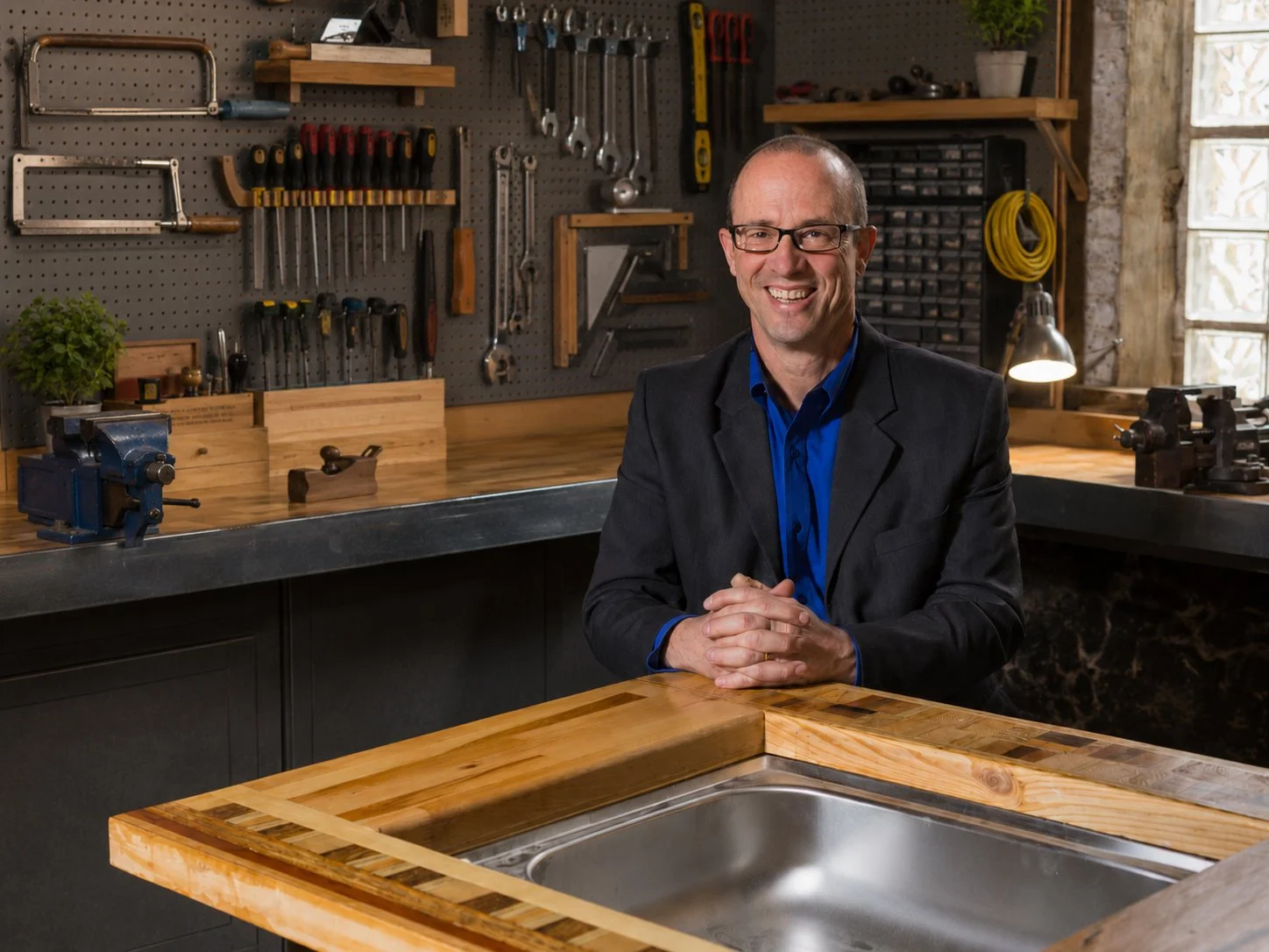 John McCloskey portrait in front of his tools