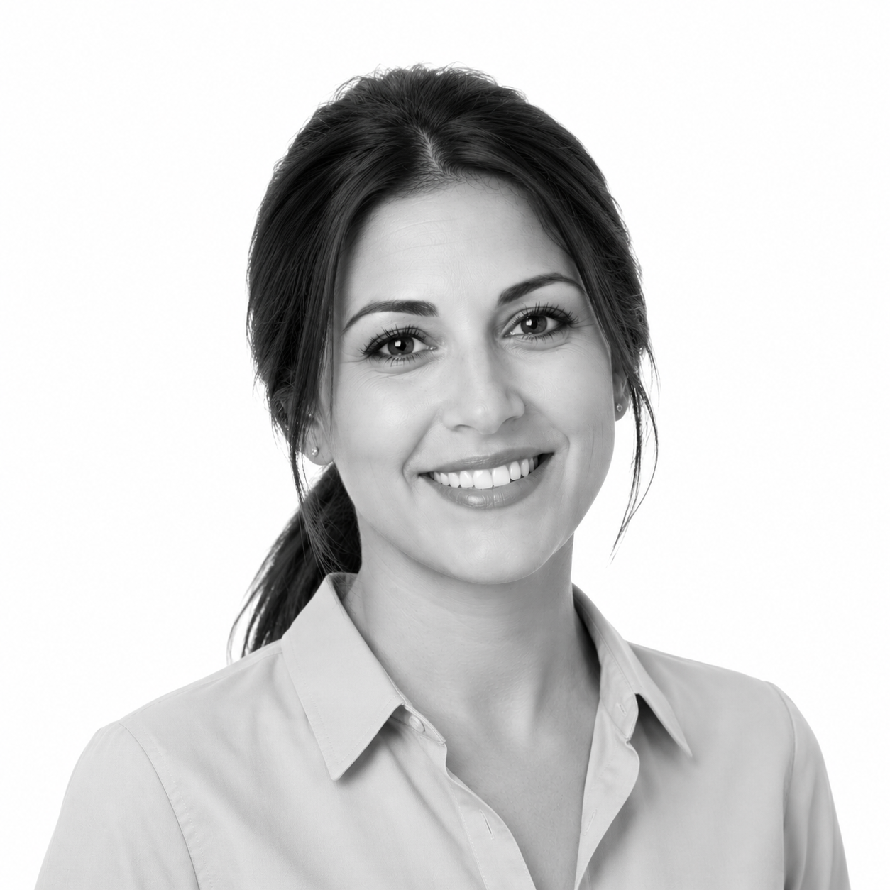 Black and white portrait of a smiling woman with dark hair tied back, wearing a collared shirt.