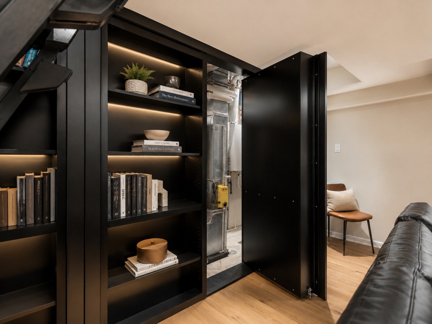 Boilers and water heaters are not the prettiest part of a home, but they still need to stay accessible. This built-in keeps the mechanicals tucked out of sight, adds useful shelving, and helps the basement feel clean, comfortable, and fully finished.