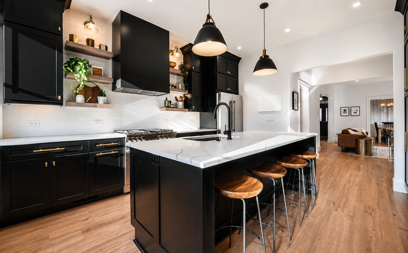 Modern kitchen with black cabinets and white countertops