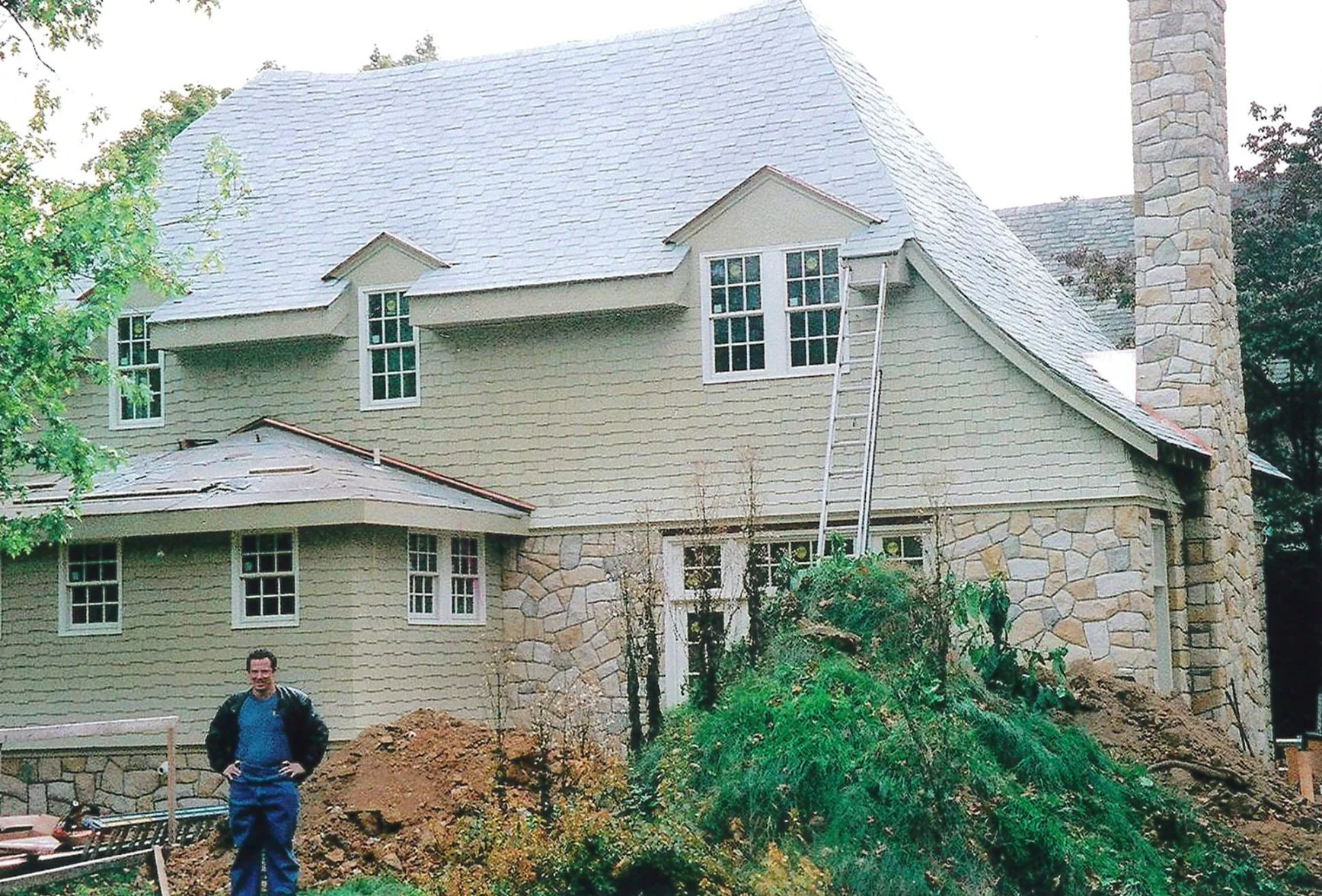 John McCloskey in front of a home