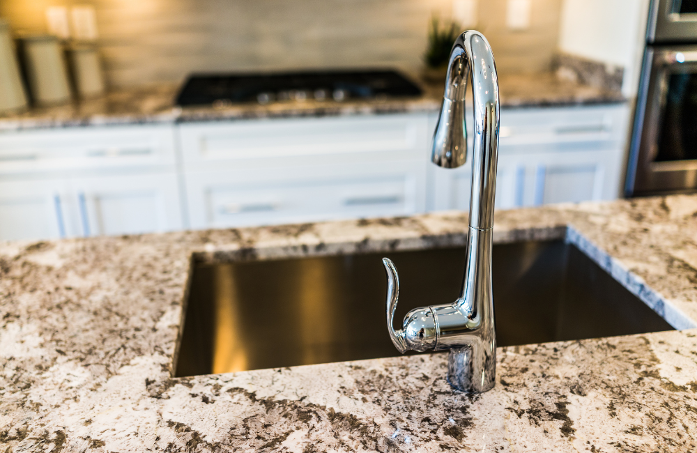 Chrome faucet and a granite kitchen countertop