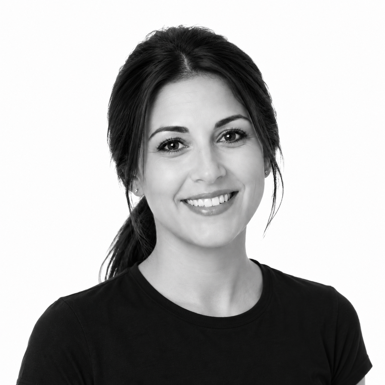 Black-and-white portrait of a young woman with dark hair tied back, smiling, wearing a black top, against a plain white background.