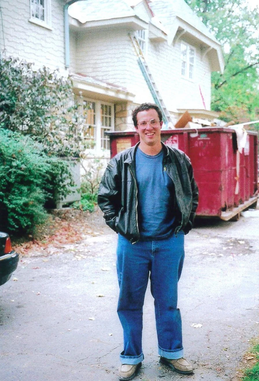 John McCloskey in front of a home