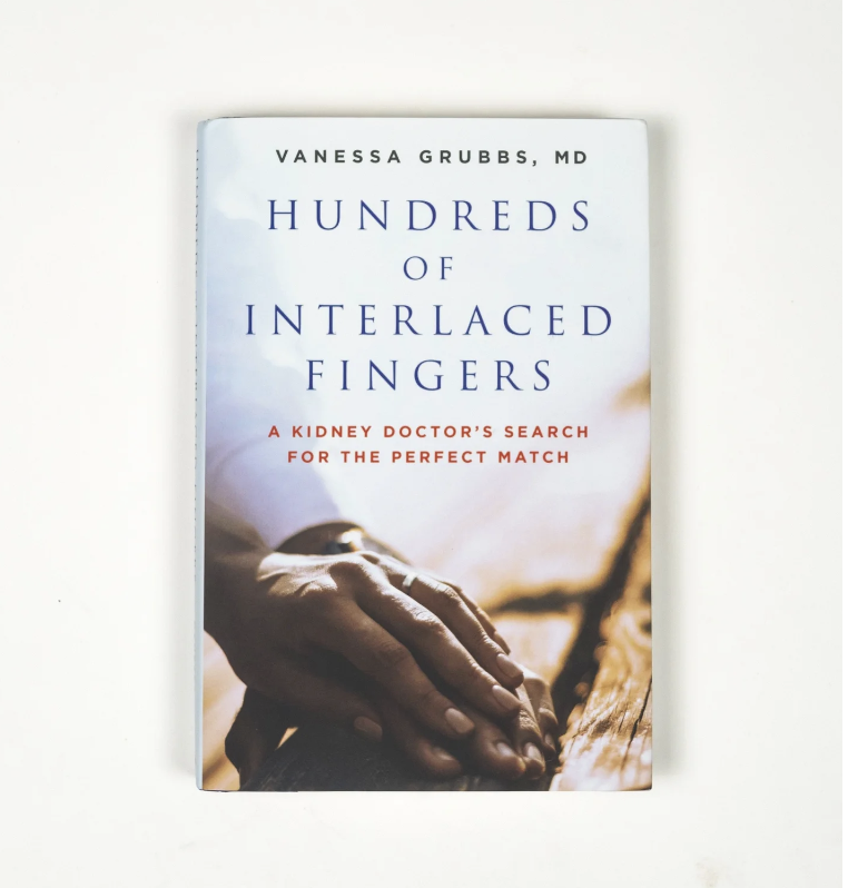 Book titled 'Hundreds of Interlaced Fingers' by Vanessa Grubbs, MD, with a cover photo of a hand gently resting on a wooden surface.