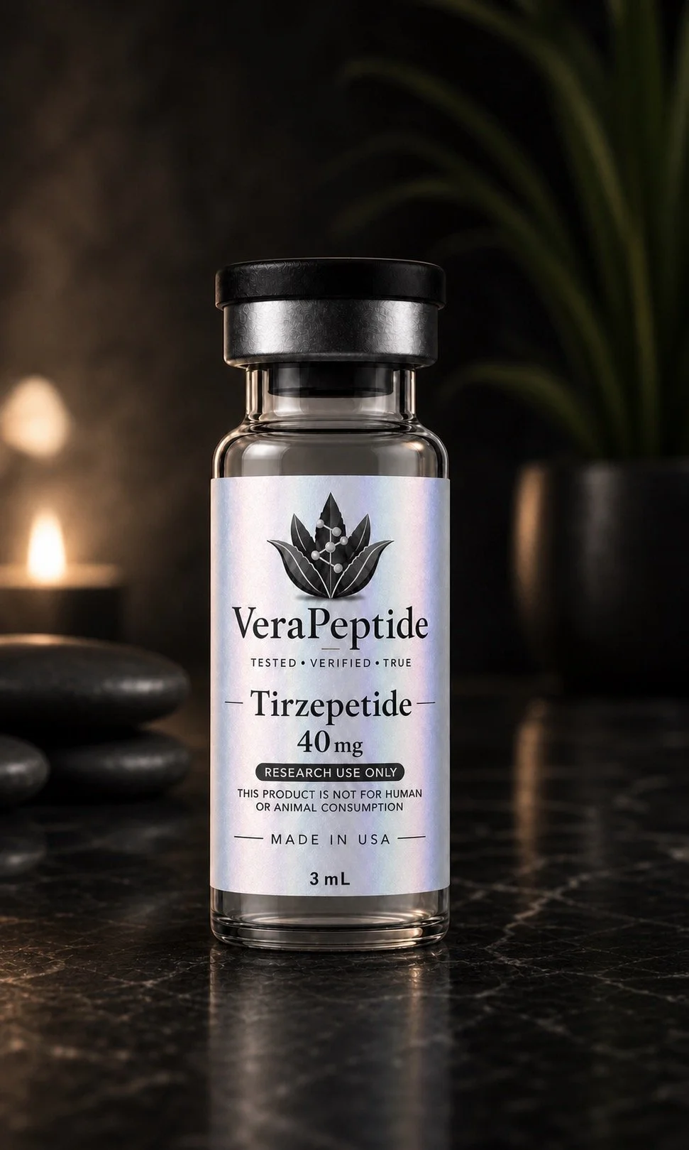 A small glass vial labeled Vera Peptide, containing Tirzepatide 40 mg, with a black lid, sitting on a black surface with blurred black stones and greenery in the background.