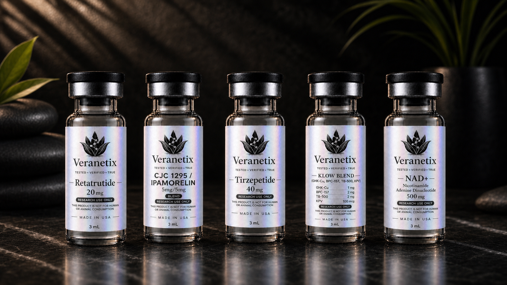 Five small bottles labeled with the brand name Veranetix, containing various research chemicals placed on a dark surface with plants in the background.