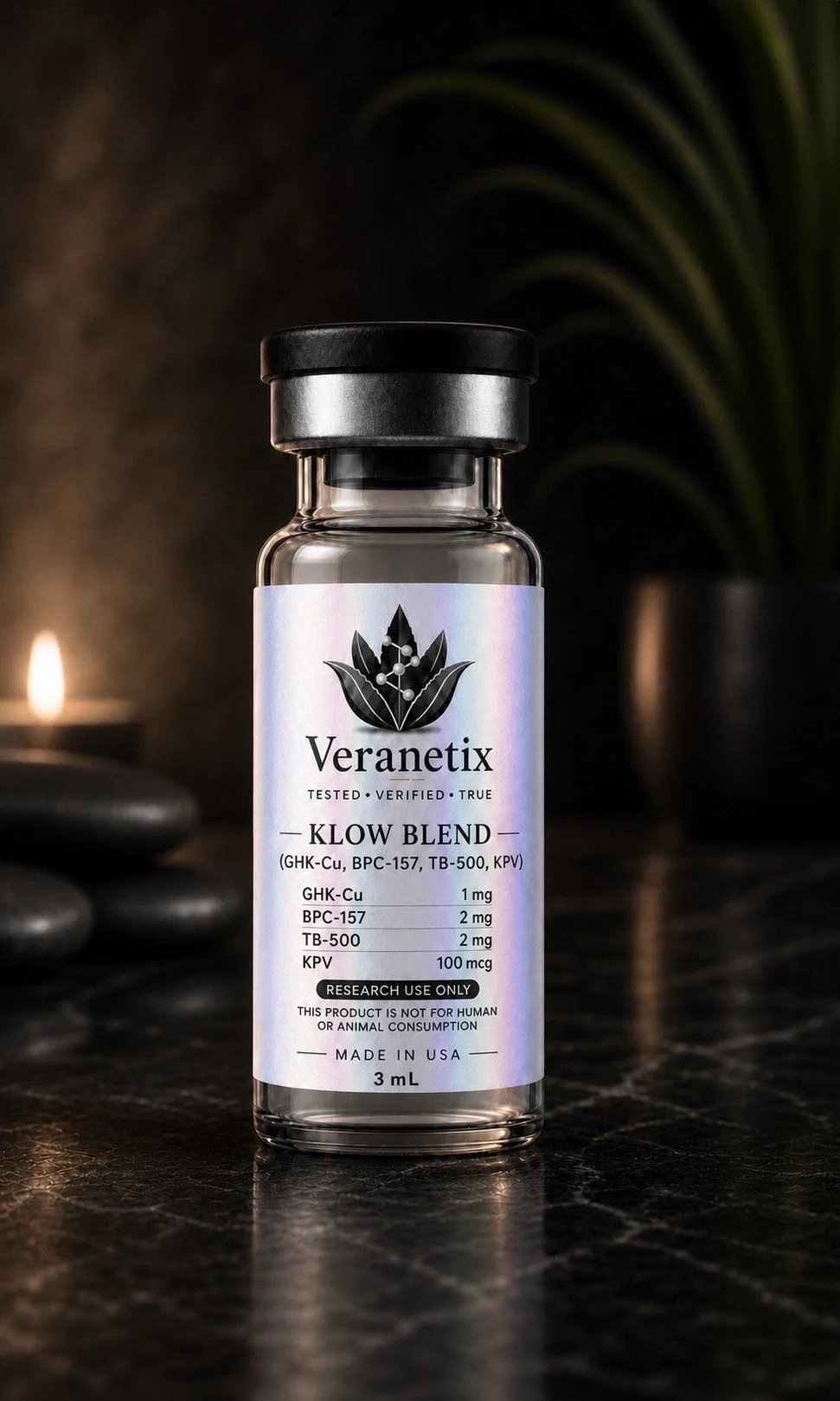 A small glass vial labeled Veranetix with a black lid, sitting on a dark surface with a blurred background. The label specifies it contains a KLOW blend, tested and verified, with research use only notes, and states it is made in the USA.