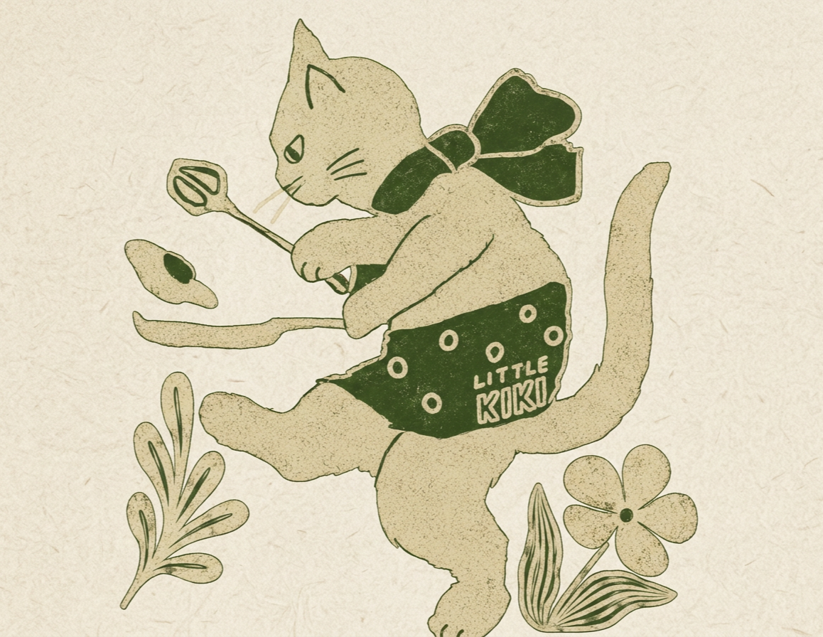 A cartoon illustration of a cat wearing a polka dot diaper labeled "Little Koko," with a bow around its neck, sitting on a moon-shaped surface, holding a fork with a fried egg, and surrounded by flowers and leaves.