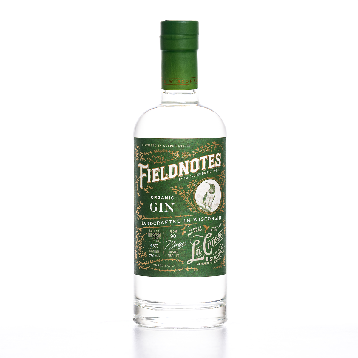 Bottle of Field Notes organic gin with green label and cap, featuring a bird illustration and detailed text about the gin's origin and content.
